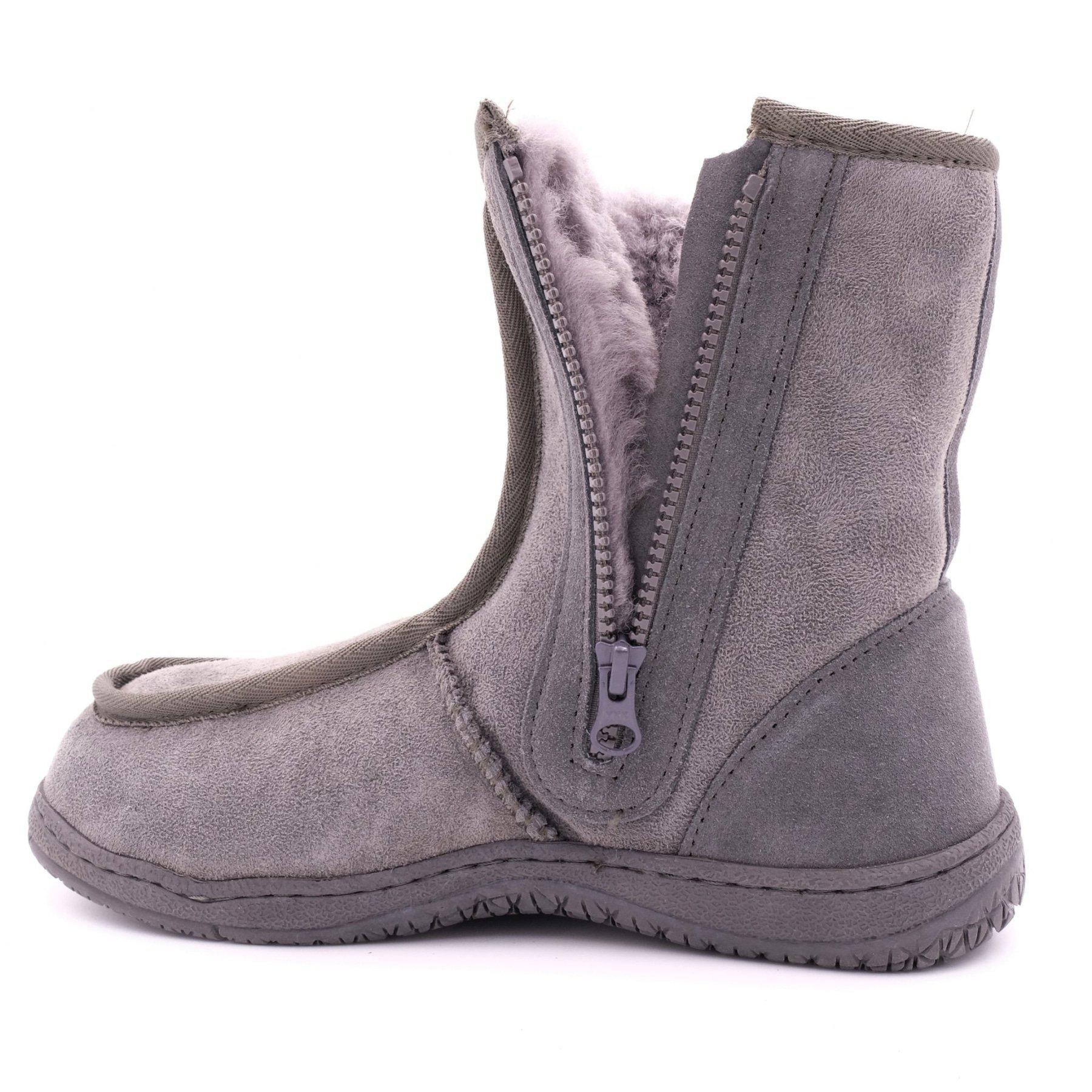 Grey sheepskin UGG boot with zipper, plush lining, and rubber sole on white background