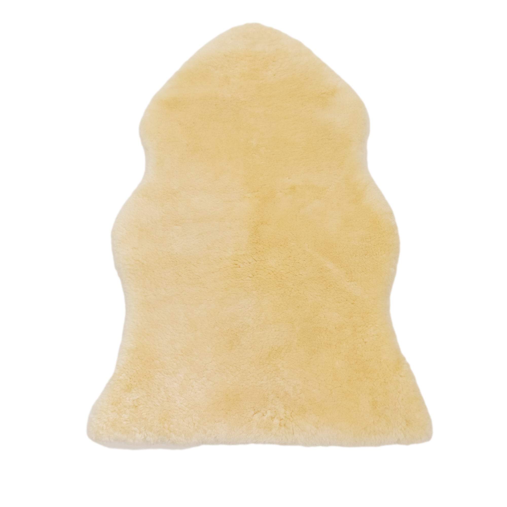 Natural cream medical sheepskin health rug with soft wool texture on white background