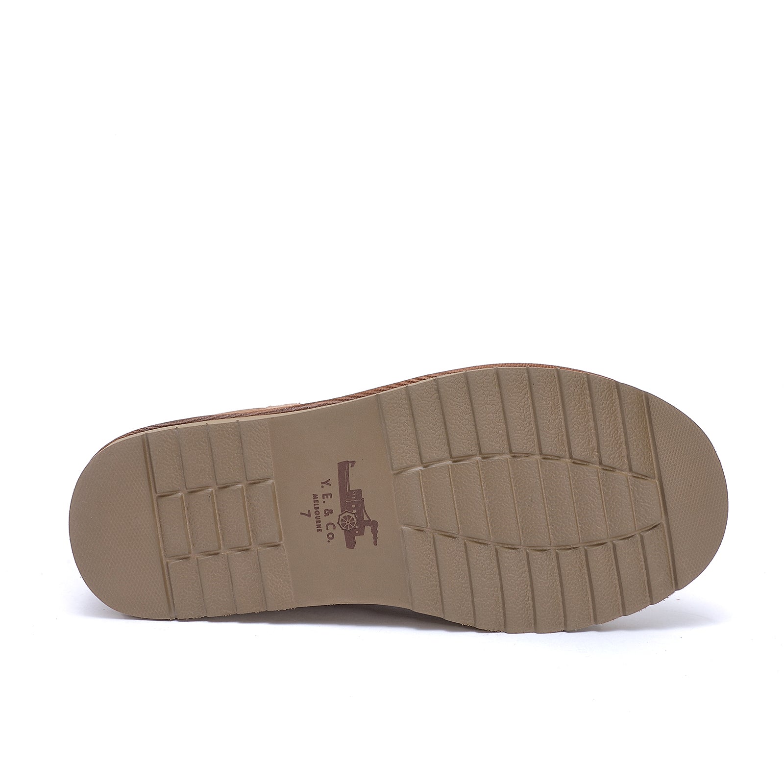 Beige rubber sole with treaded pattern on white background, bottom view. - Yellow Earth Australia
