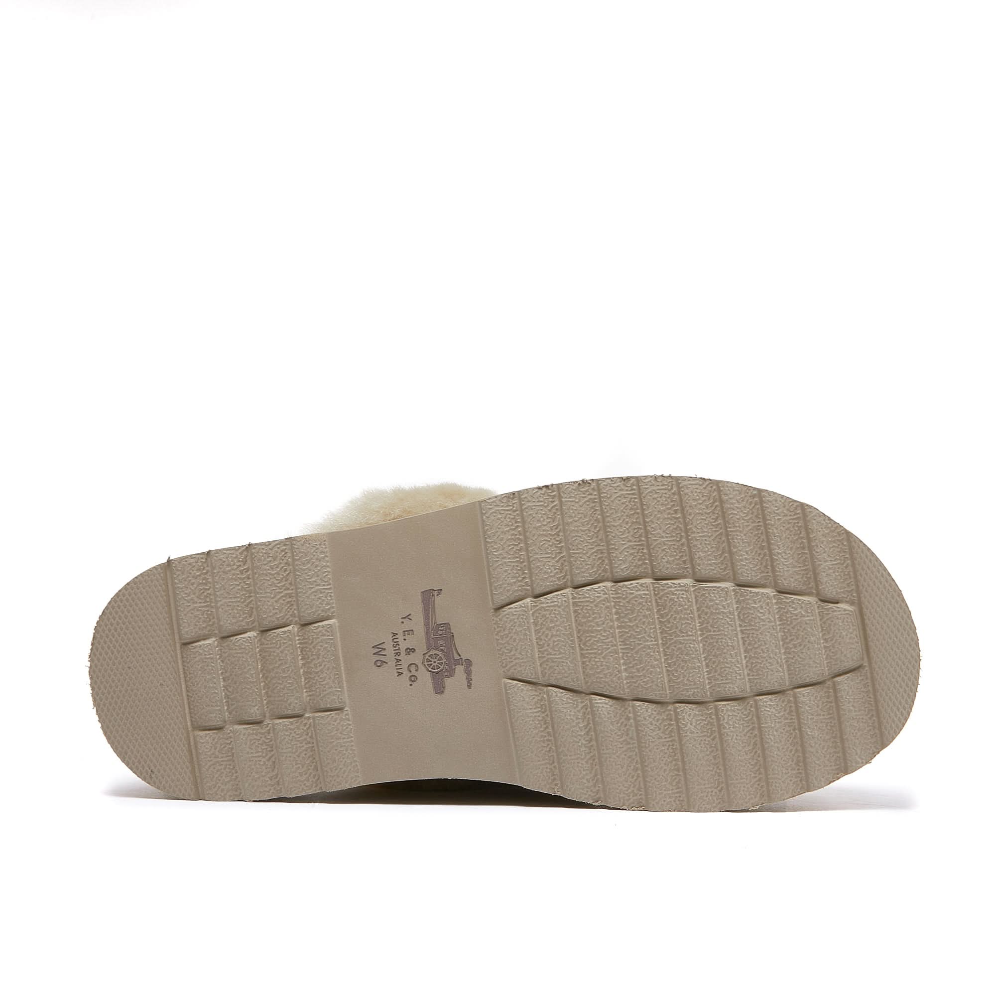 Cream sheepskin slipper sole view showing textured beige rubber outsole. - Yellow Earth Australia