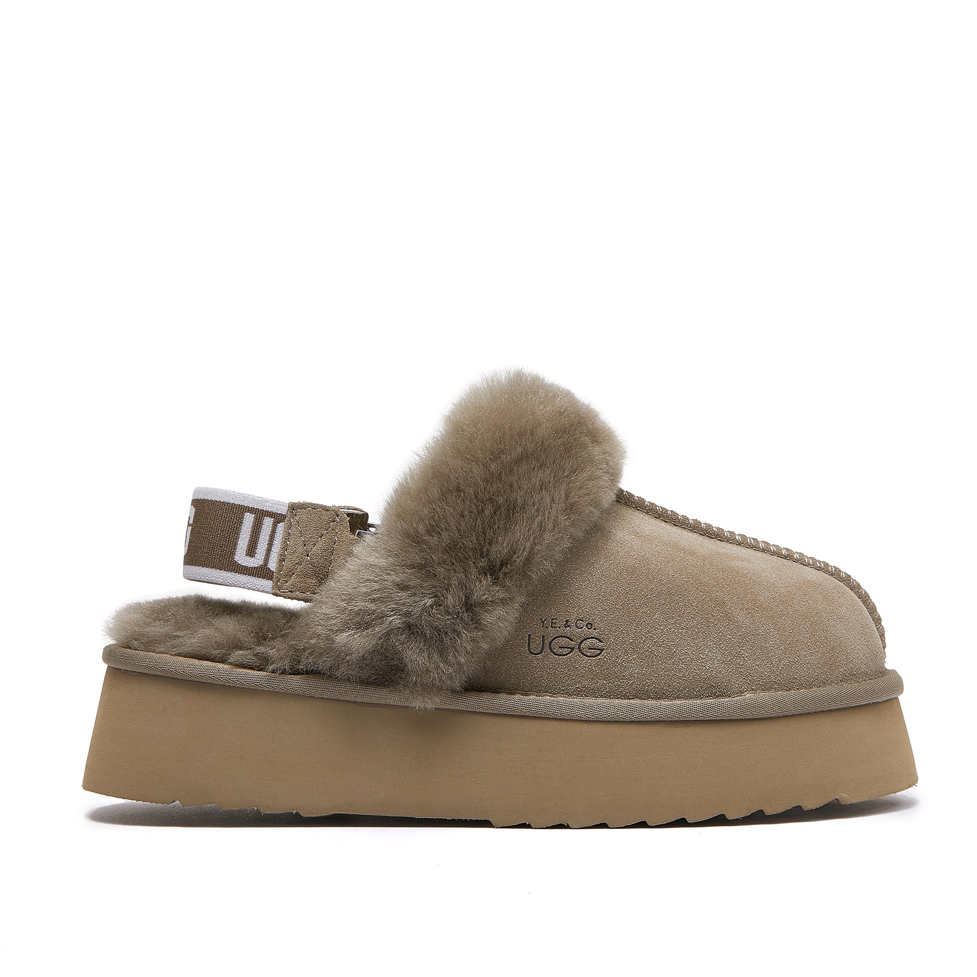 Beige sheepskin UGG slipper with fur lining, platform sole, and branded elastic heel strap