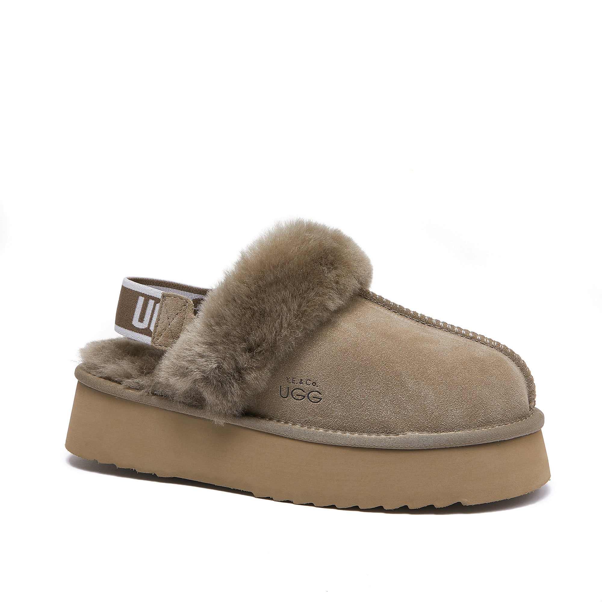Beige sheepskin UGG slipper with fur lining, platform sole, and branded elastic heel strap