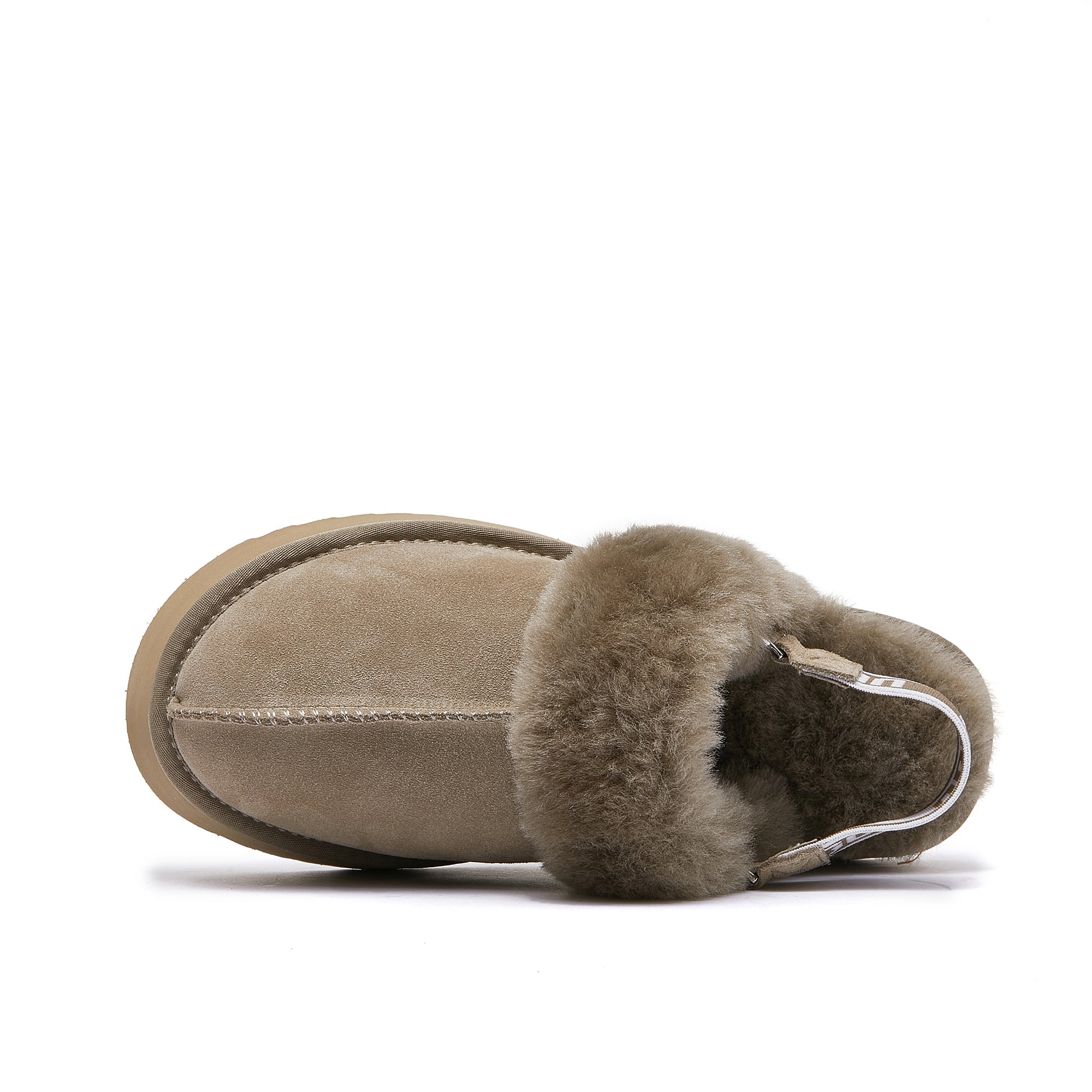 Tan sheepskin UGG boot with plush fur lining, top view on white background