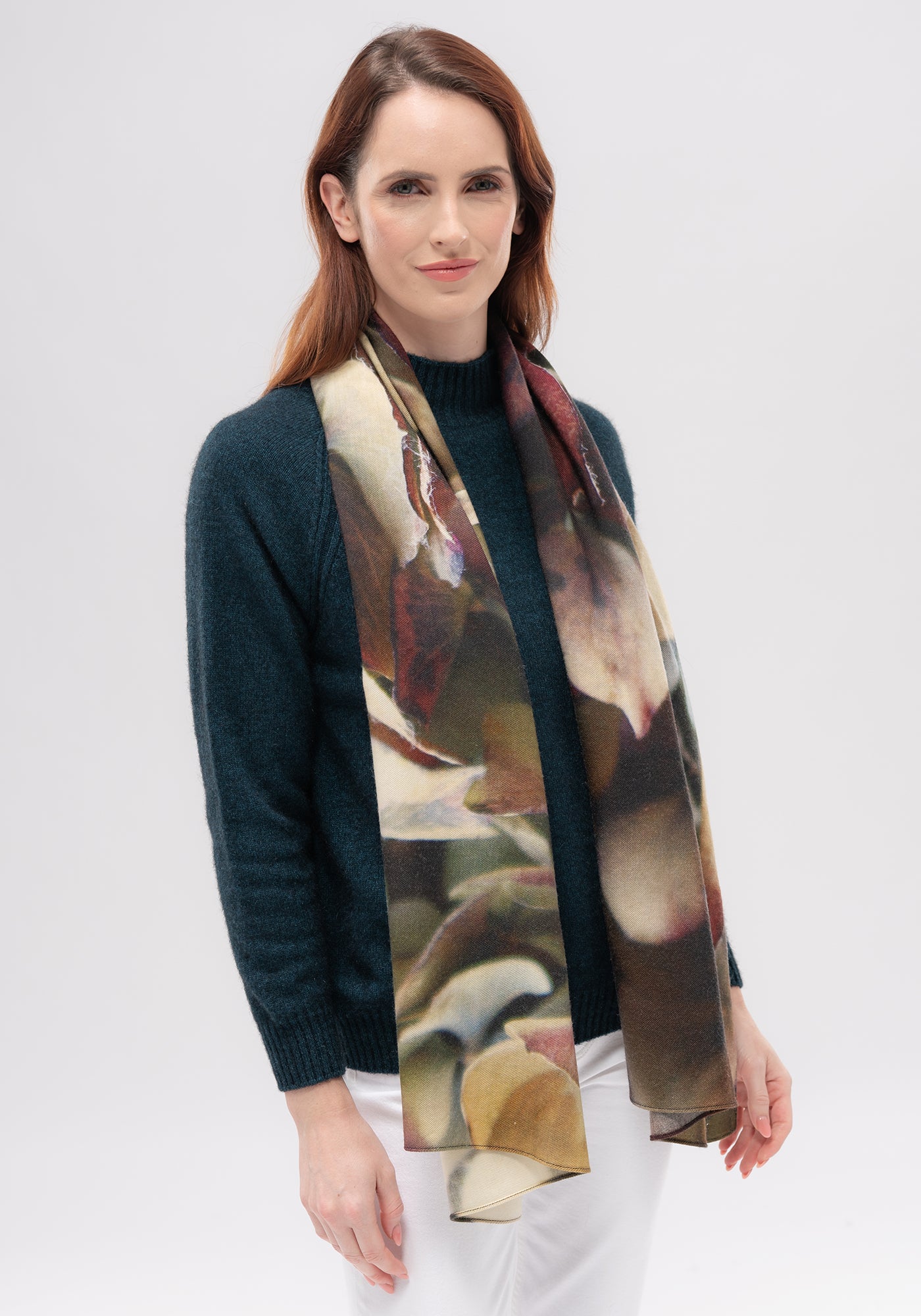 Woman wearing dark teal wool cardigan with multicoloured floral scarf, front view. - Yellow Earth Australia