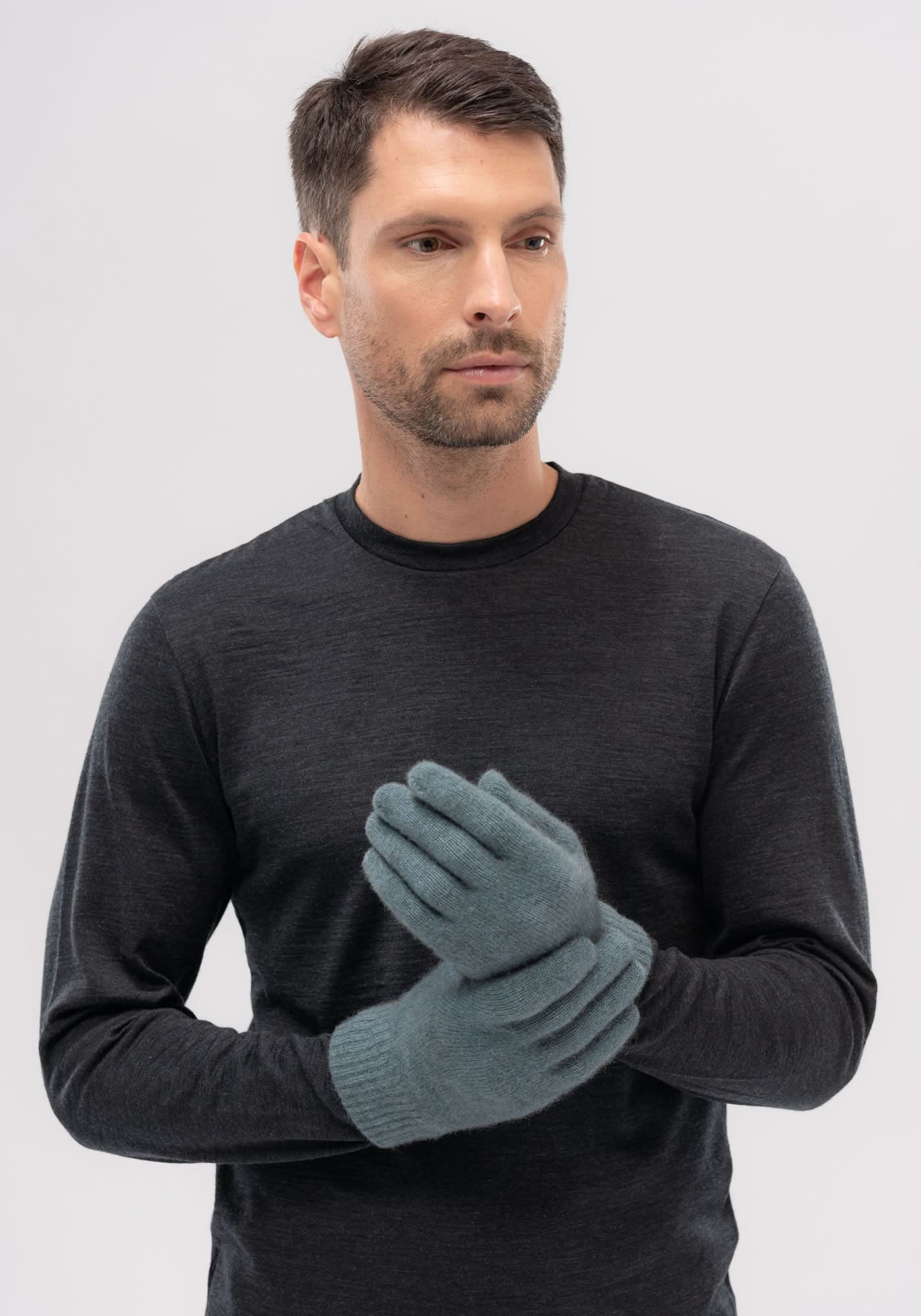 Man wearing grey knit gloves with charcoal sweater, front view. - Yellow Earth Australia