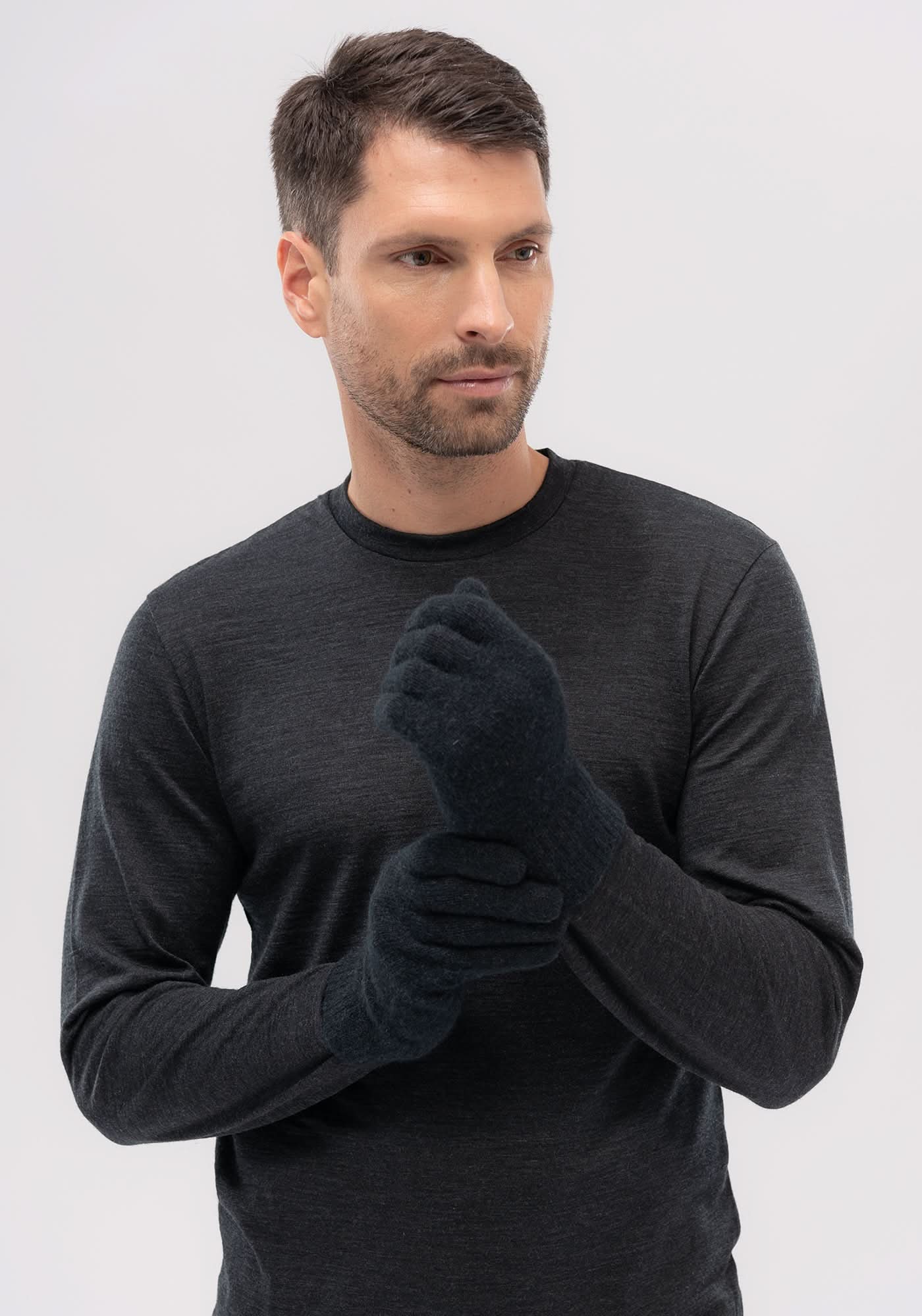 Black wool gloves displayed on model wearing charcoal long-sleeve shirt, front view. - Yellow Earth Australia