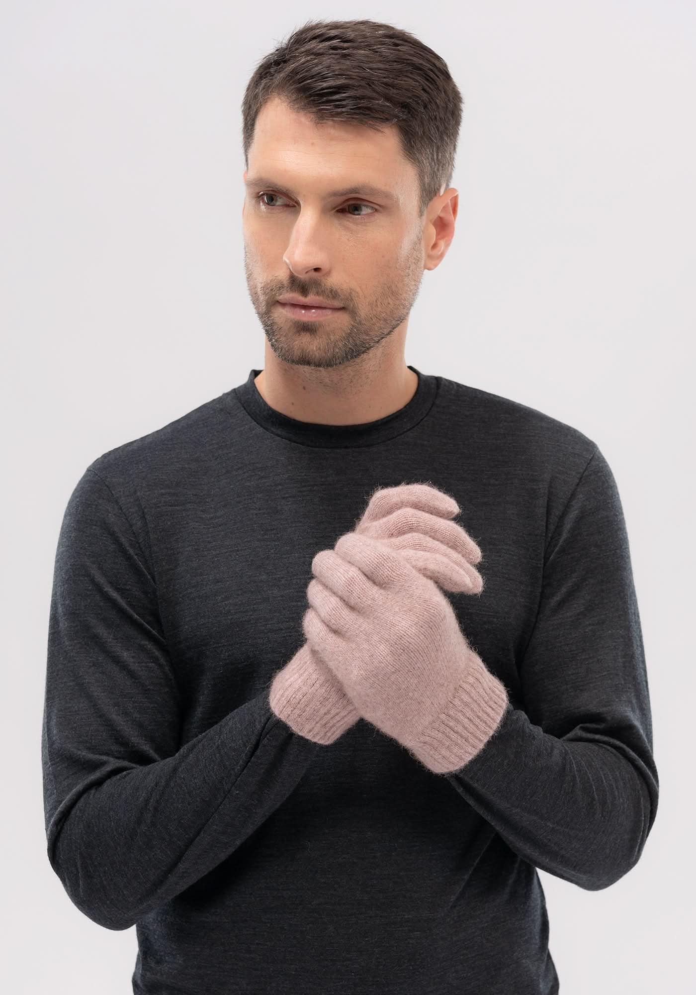Pink ribbed wool gloves displayed on man wearing charcoal sweater, front view. - Yellow Earth Australia