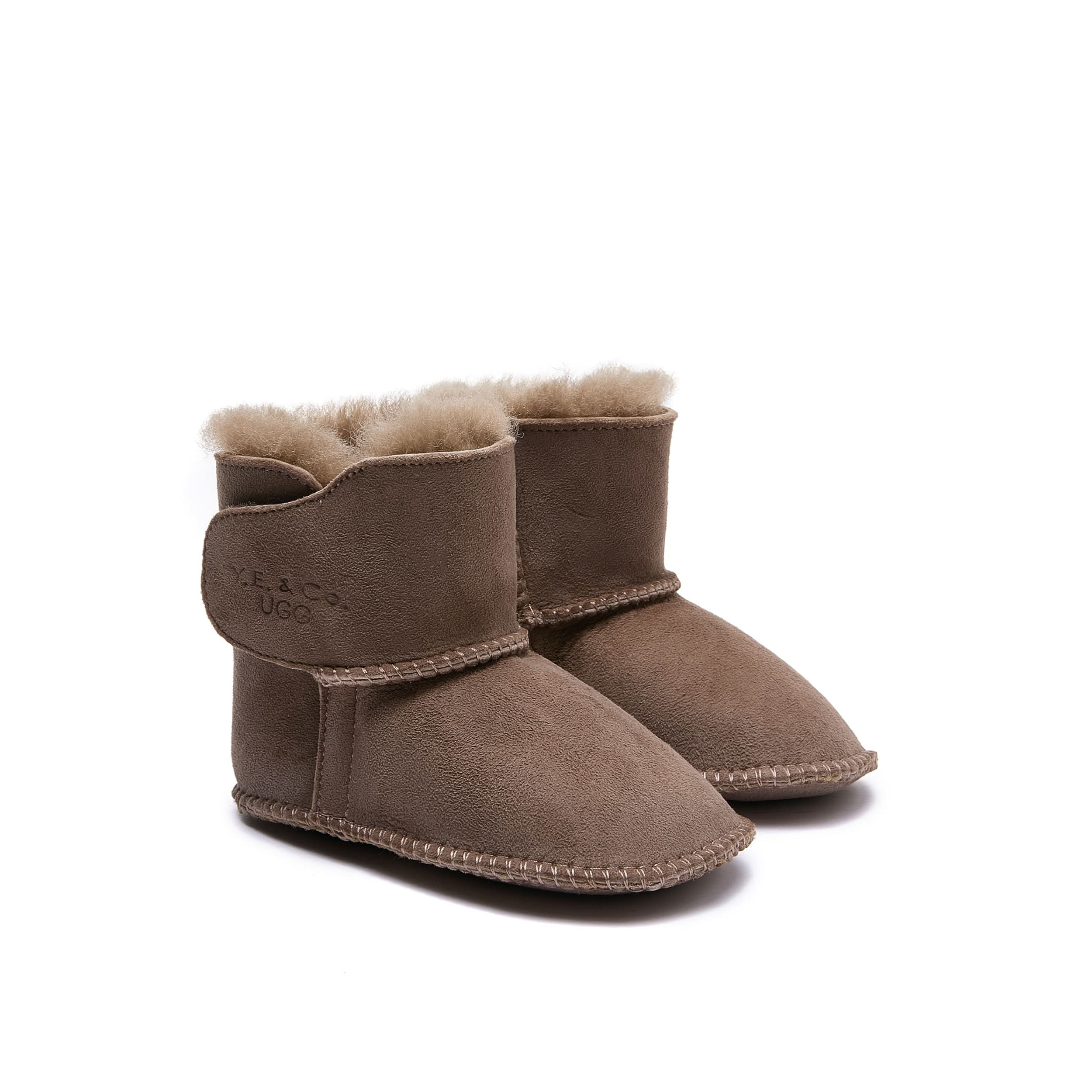 Pair of beige sheepskin boots with wool lining, shown from the side angle. - Yellow Earth Australia
