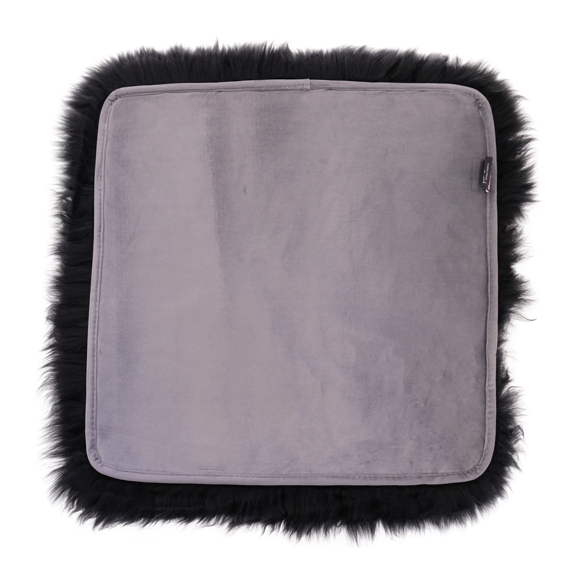 Grey sheepskin seat pad with black wool fleece border, top view. - Yellow Earth Australia