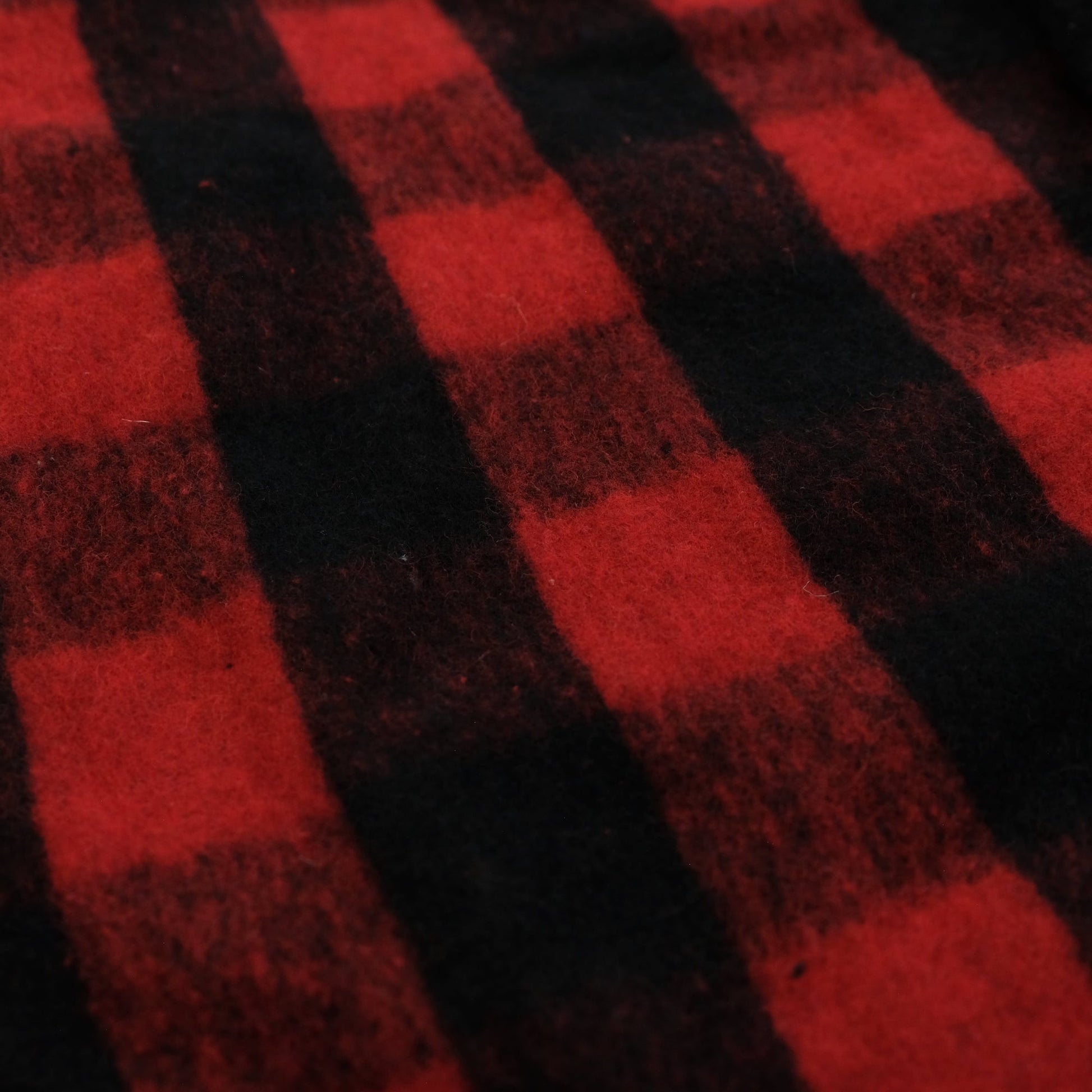 Red and black checked wool blanket with soft texture, diagonal view. - Yellow Earth Australia