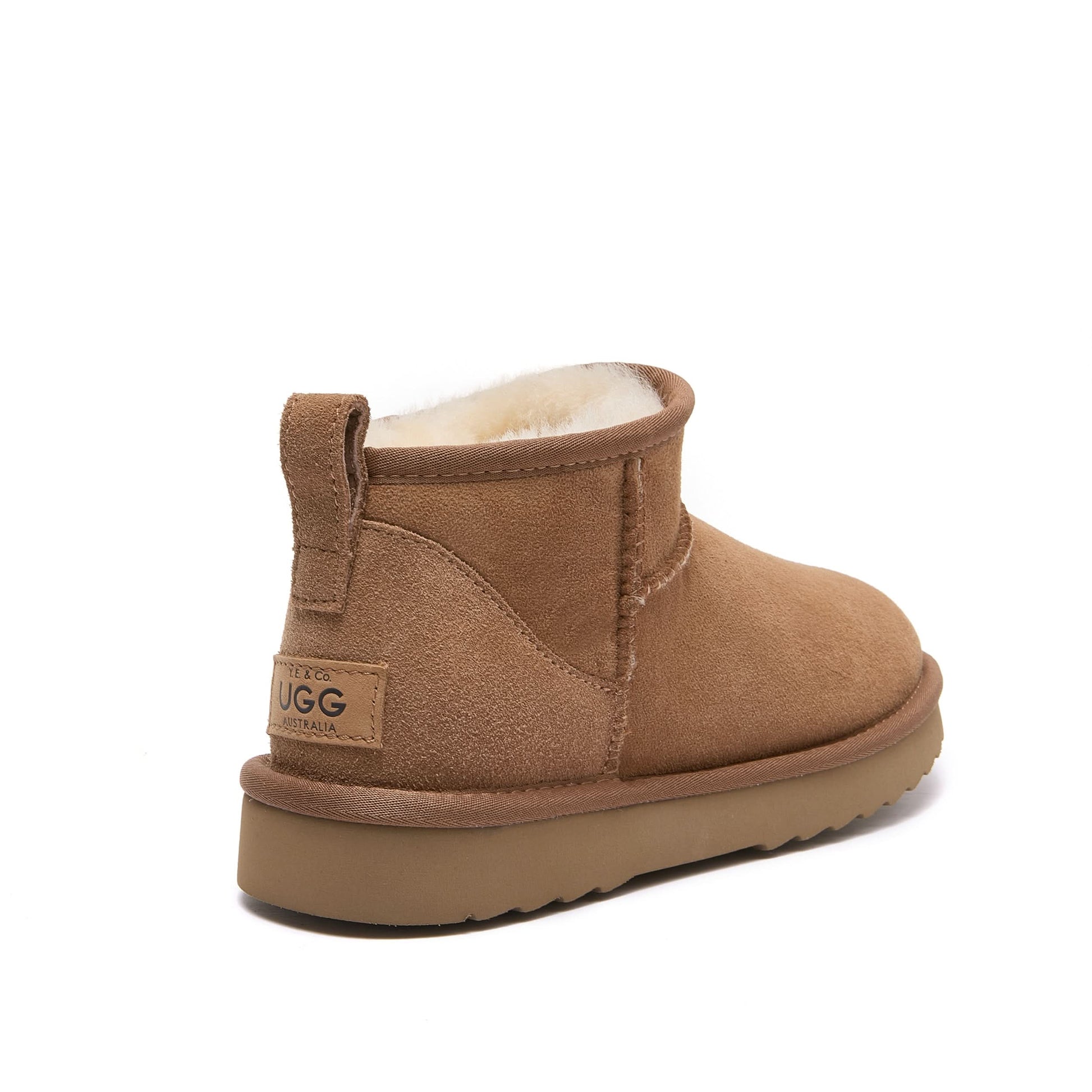 Caramel mini sheepskin boot with fleece lining, rear three-quarter view. - Yellow Earth Australia