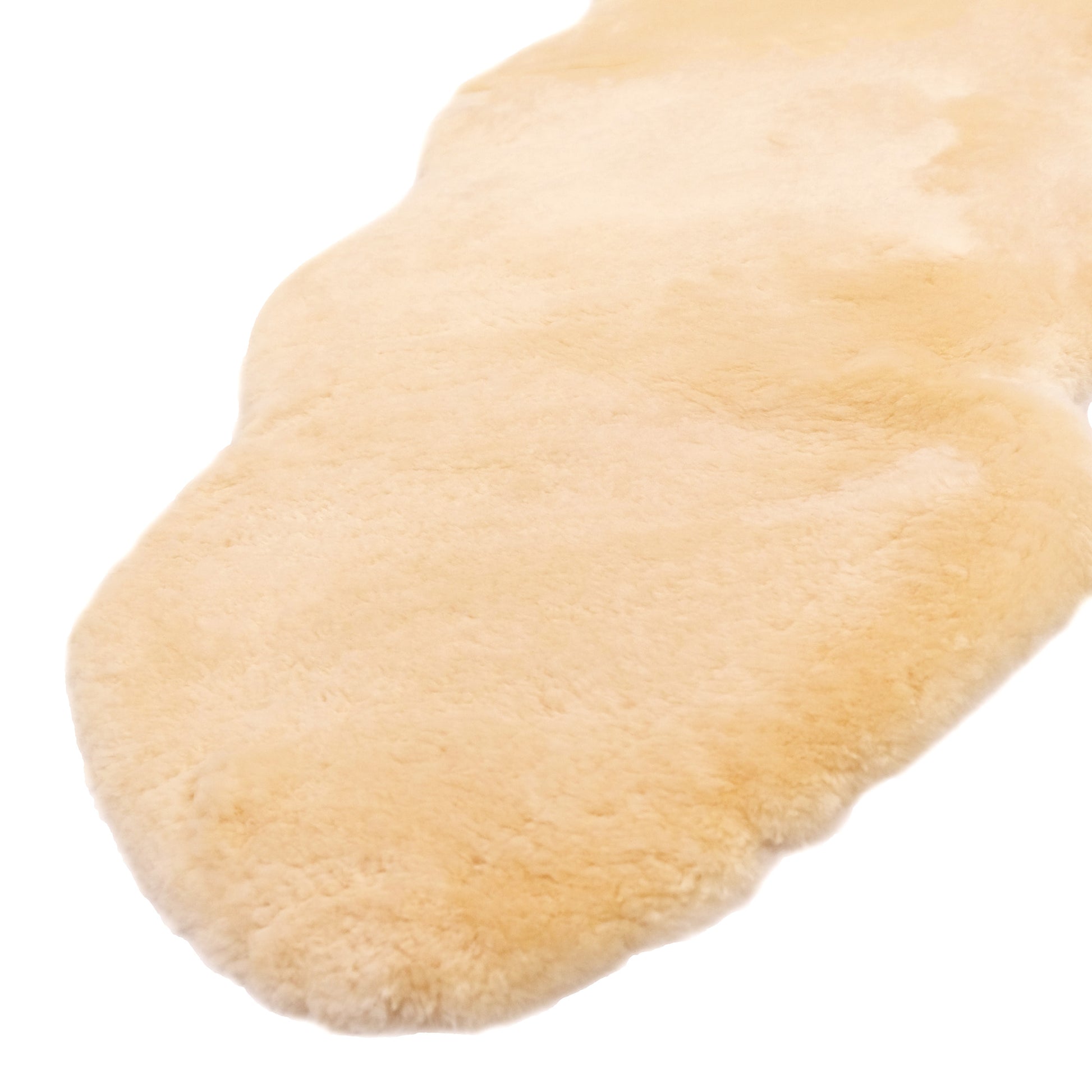 Natural sheepskin slipper sole showing soft cream wool texture and curved shape. - Yellow Earth Australia