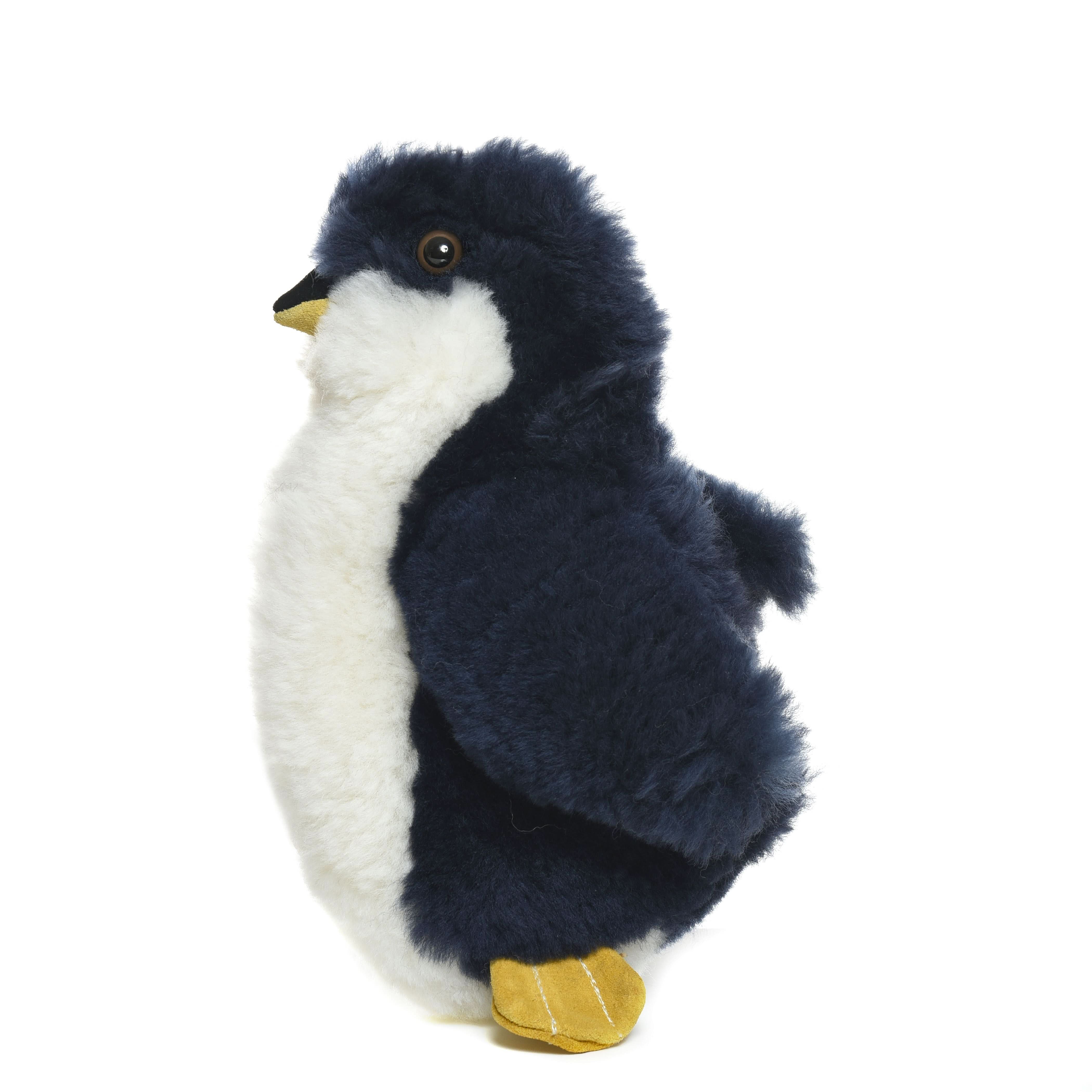 Plush black and white wool penguin toy with golden feet, side view. - Yellow Earth Australia