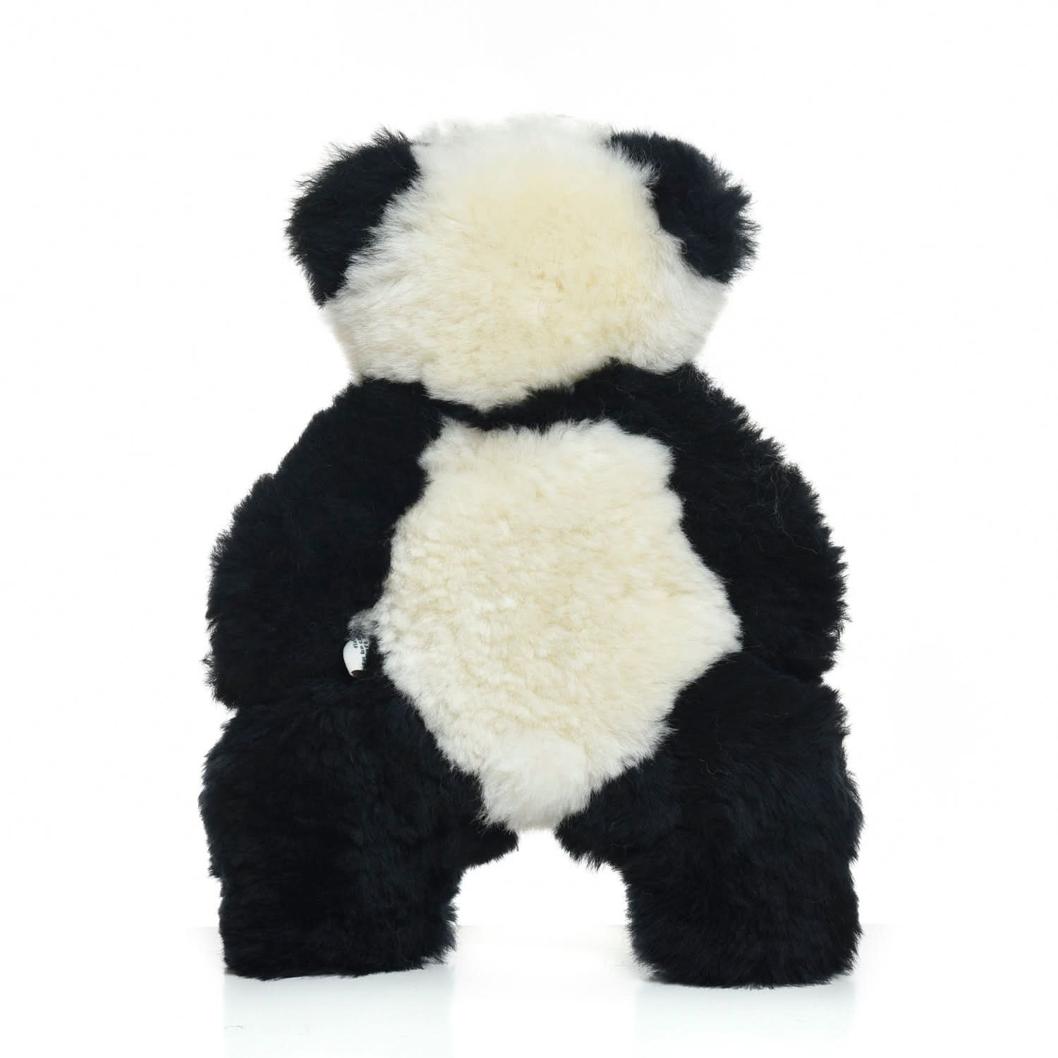 Soft black and white sheepskin panda teddy bear shown from front view. - Yellow Earth Australia