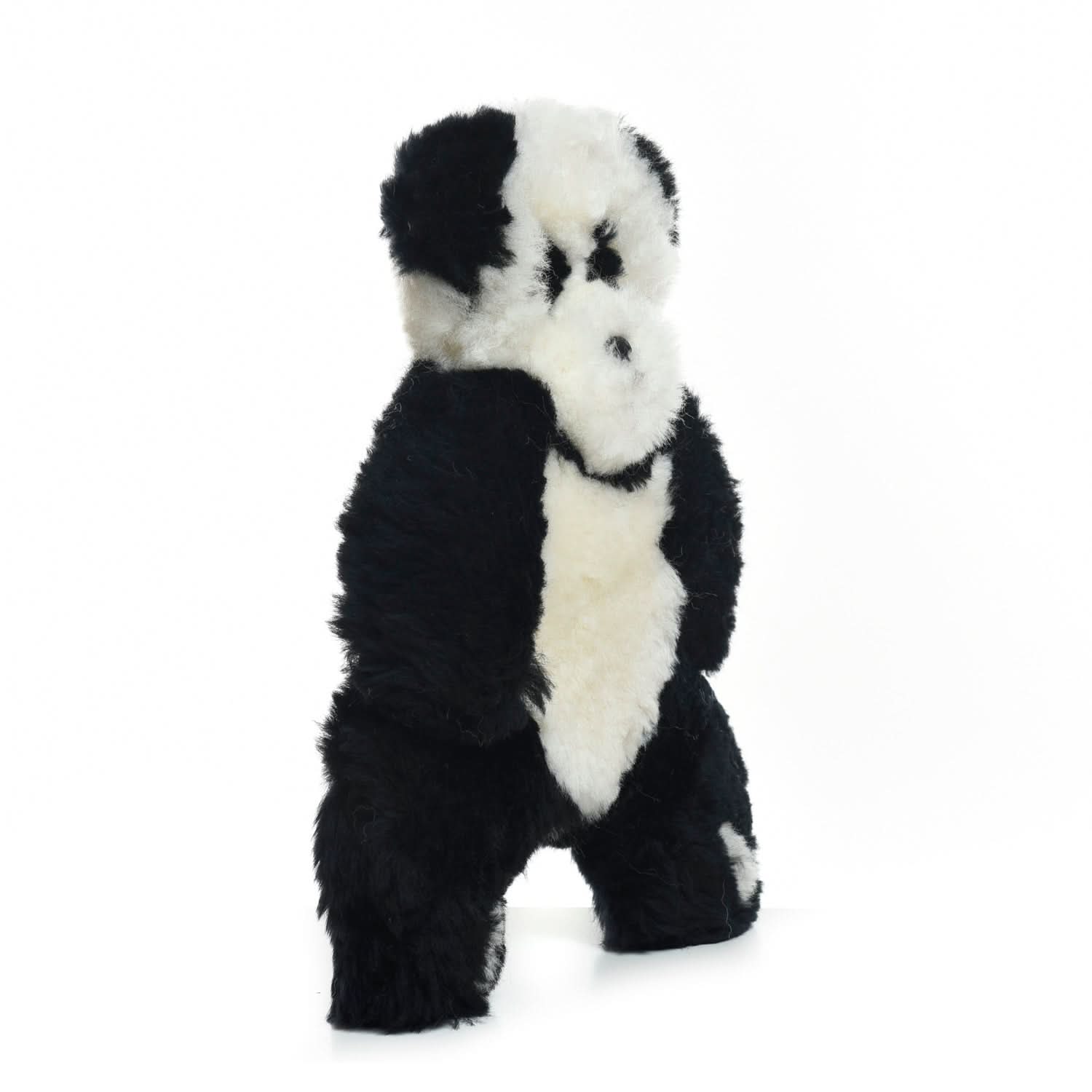 Plush black and white sheepskin panda toy standing upright on white background. - Yellow Earth Australia