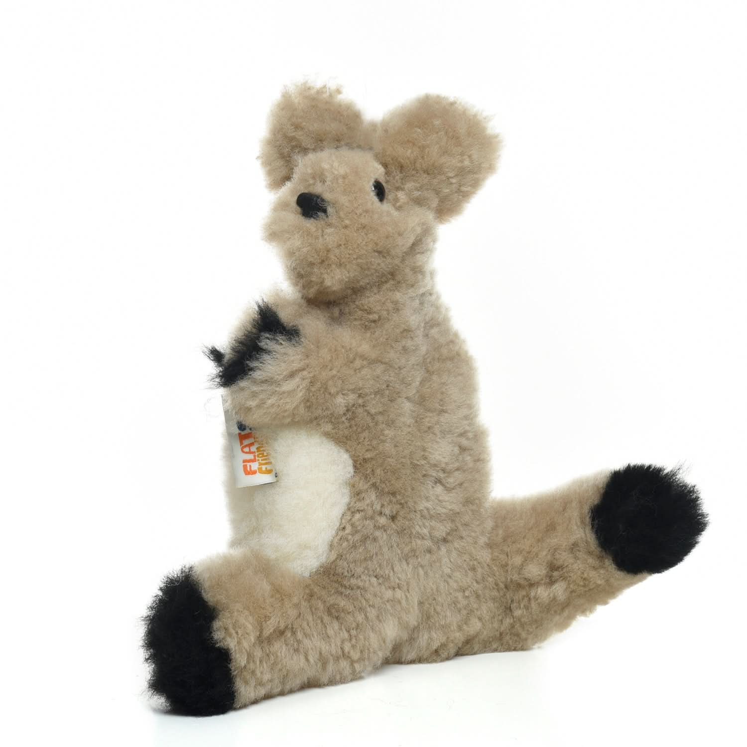 Cream wool plush llama toy with black hooves and tail, seated side view. - Yellow Earth Australia