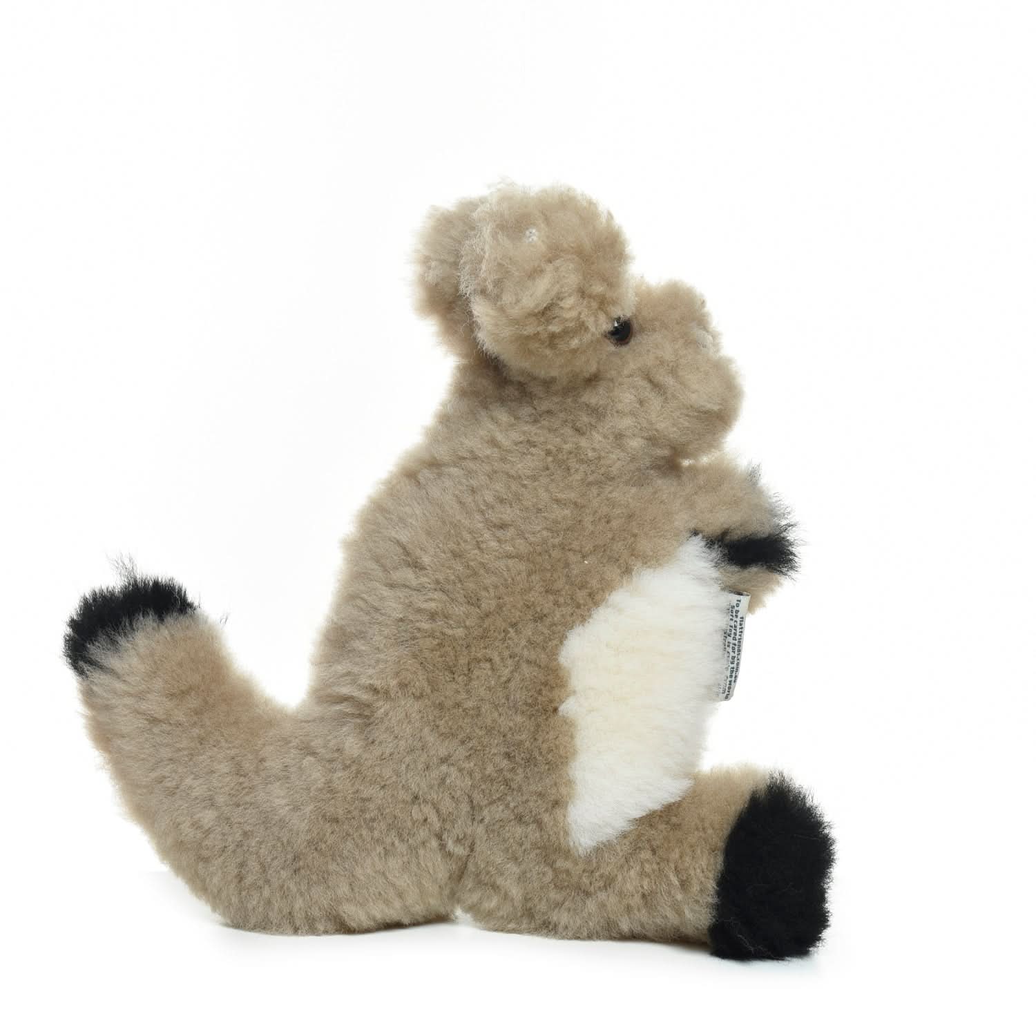 Soft cream sheepskin teddy bear with black paw pads, side view on white background. - Yellow Earth Australia