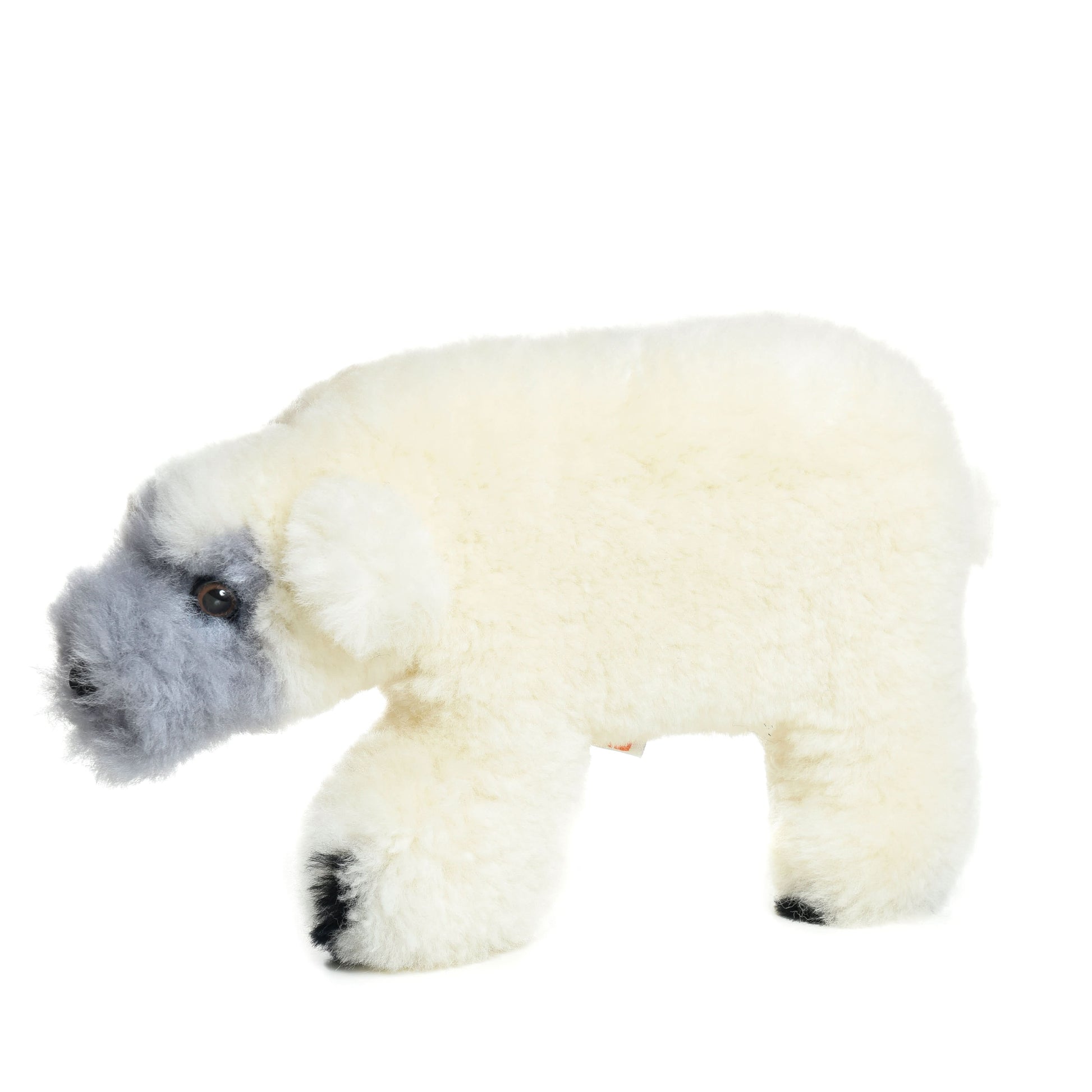 Soft white sheepskin polar bear cub plush toy with gray face, side view. - Yellow Earth Australia