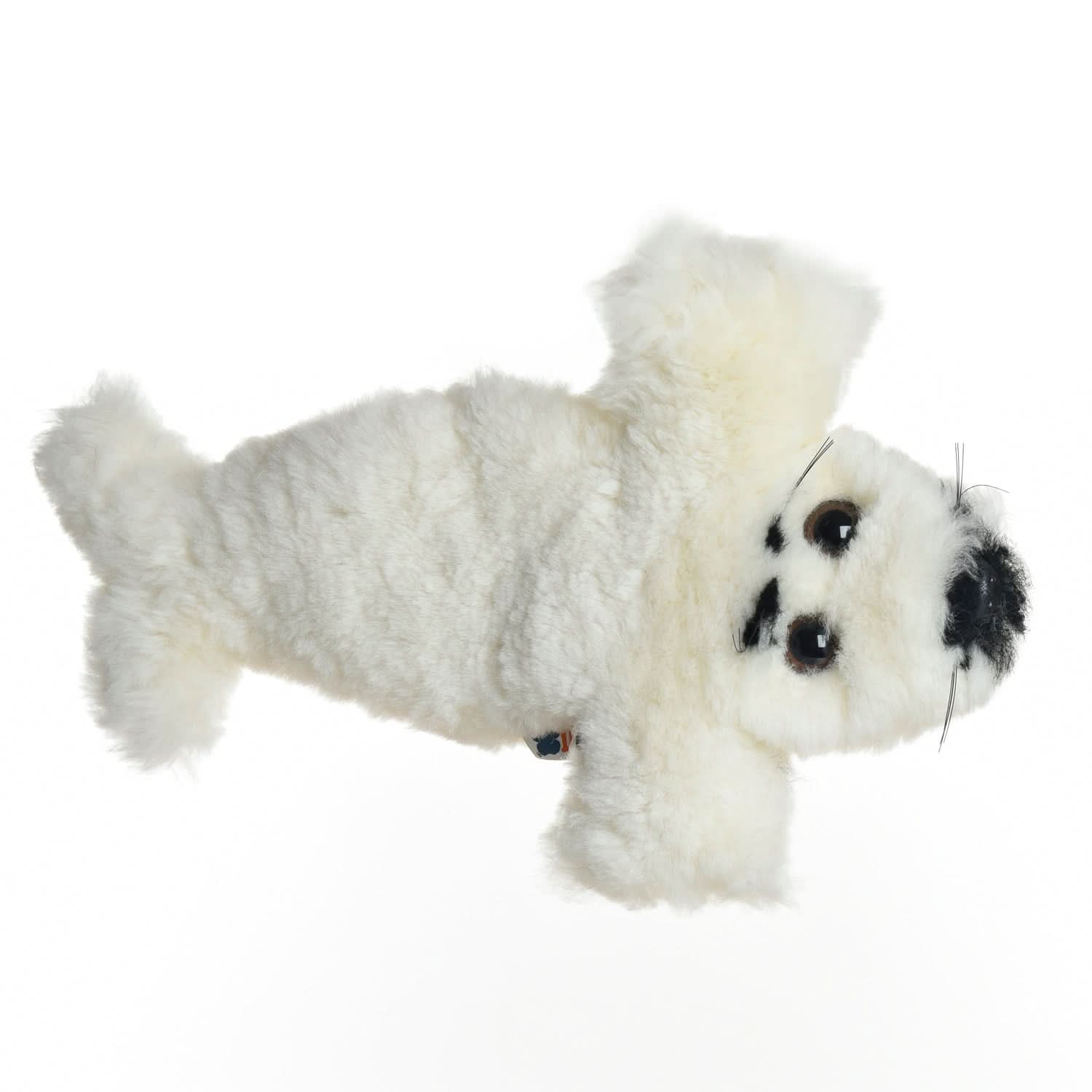 White sheepskin dog toy with black spots viewed from above on white background. - Yellow Earth Australia