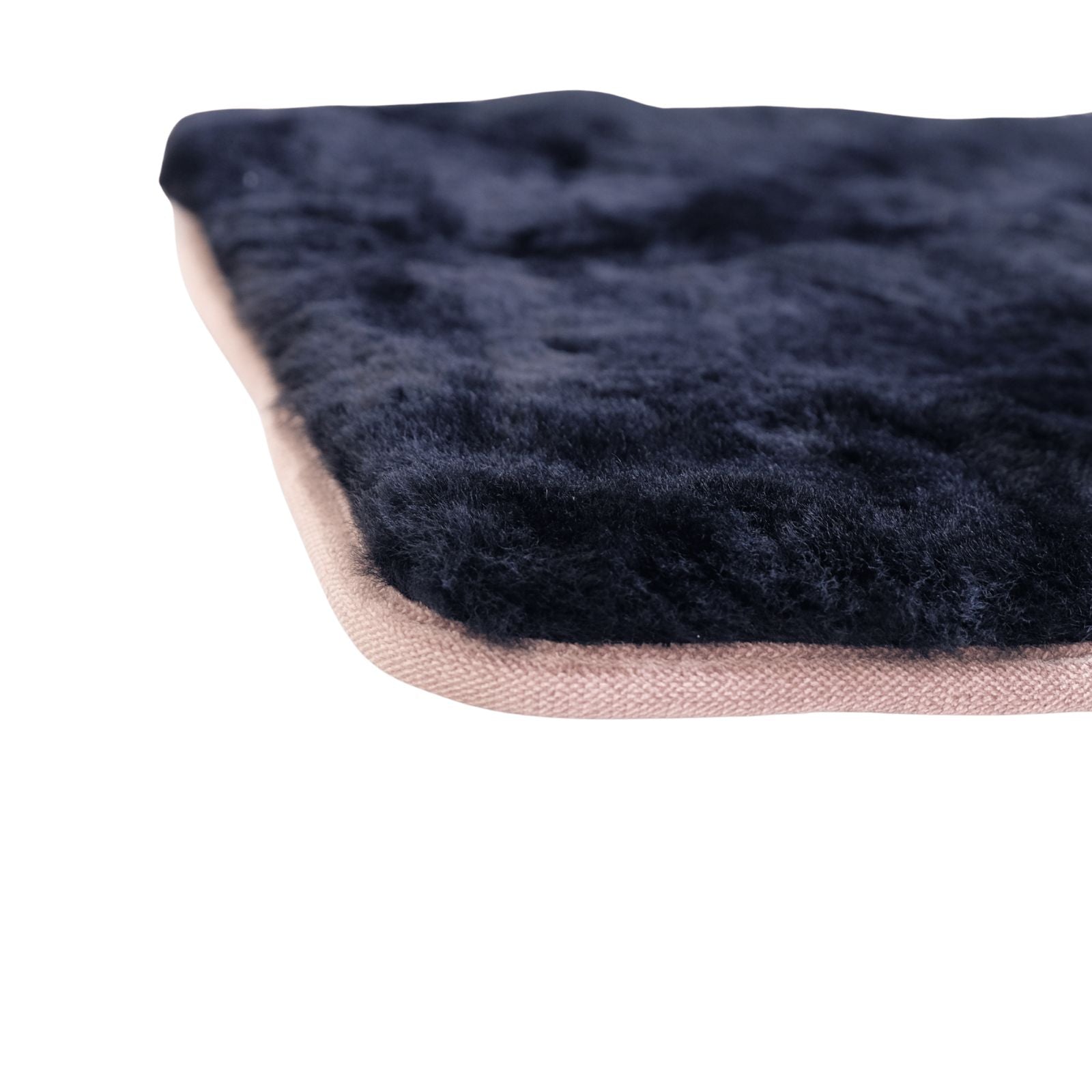 Black sheepskin rug with natural wool texture and woven backing, edge view. - Yellow Earth Australia