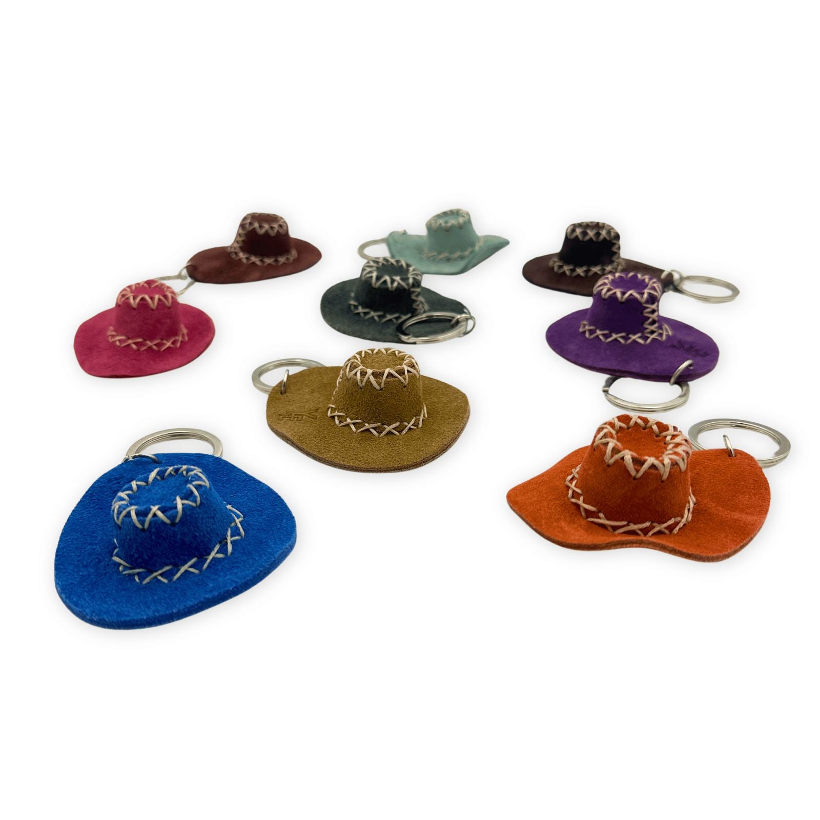 Colorful sheepskin cowboy hat keychains in various hues displayed from above. - Yellow Earth Australia