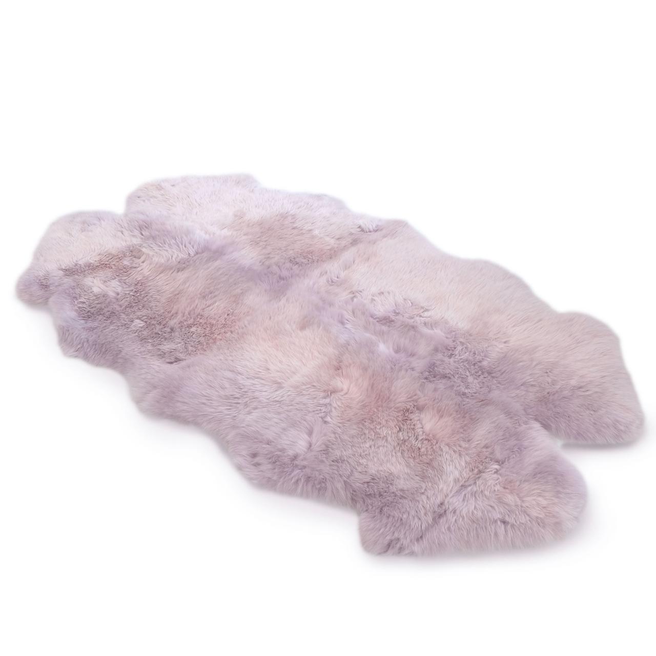 Soft lilac sheepskin rug with fluffy wool pile viewed from above on white background. - Yellow Earth Australia
