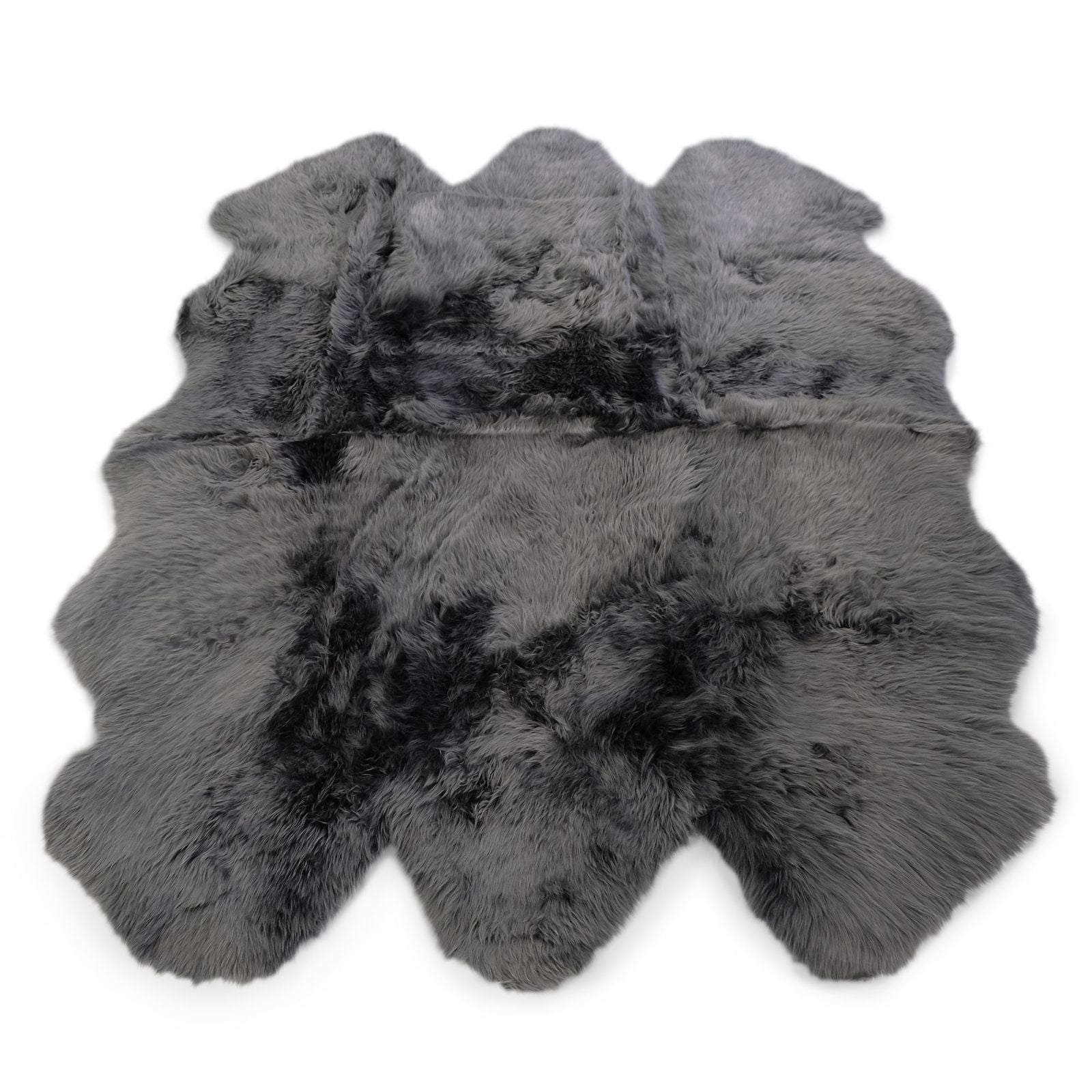 Grey sheepskin rug with black accents viewed from above on white background. - Yellow Earth Australia