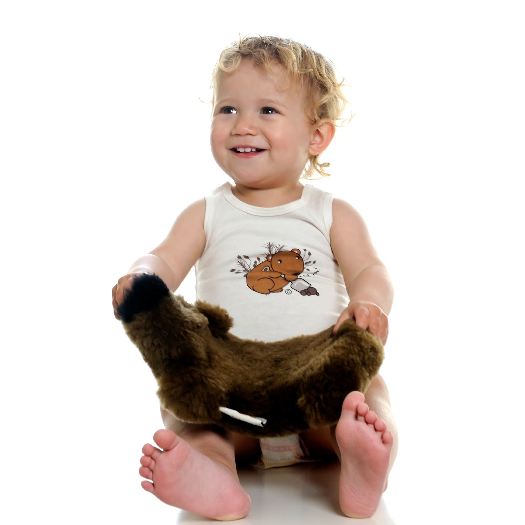 Toddler wearing brown sheepskin booties with soft wool lining, front view on white background. - Yellow Earth Australia