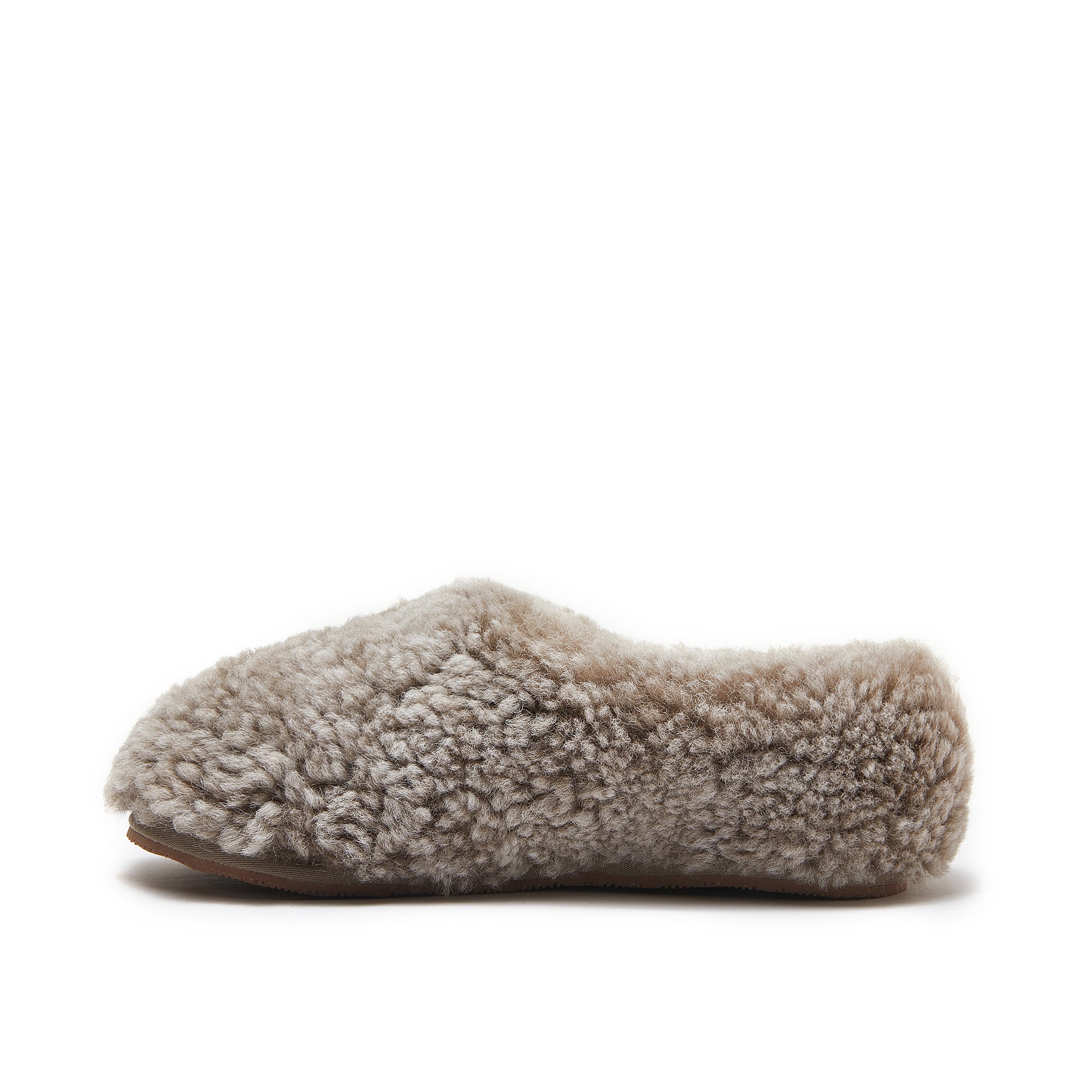 Beige sheepskin slipper with curly wool upper and sole, side view. - Yellow Earth Australia
