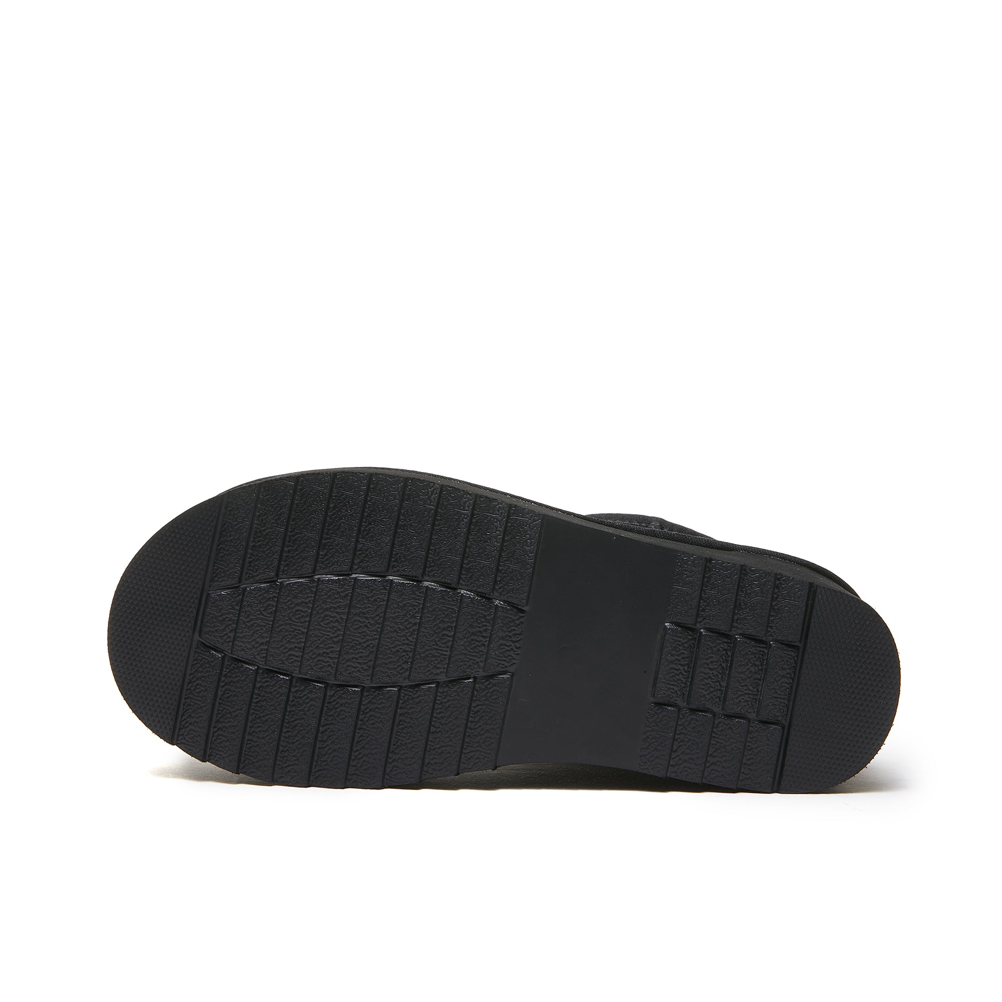 Black sheepskin slipper sole showing textured rubber tread pattern from bottom view. - Yellow Earth Australia