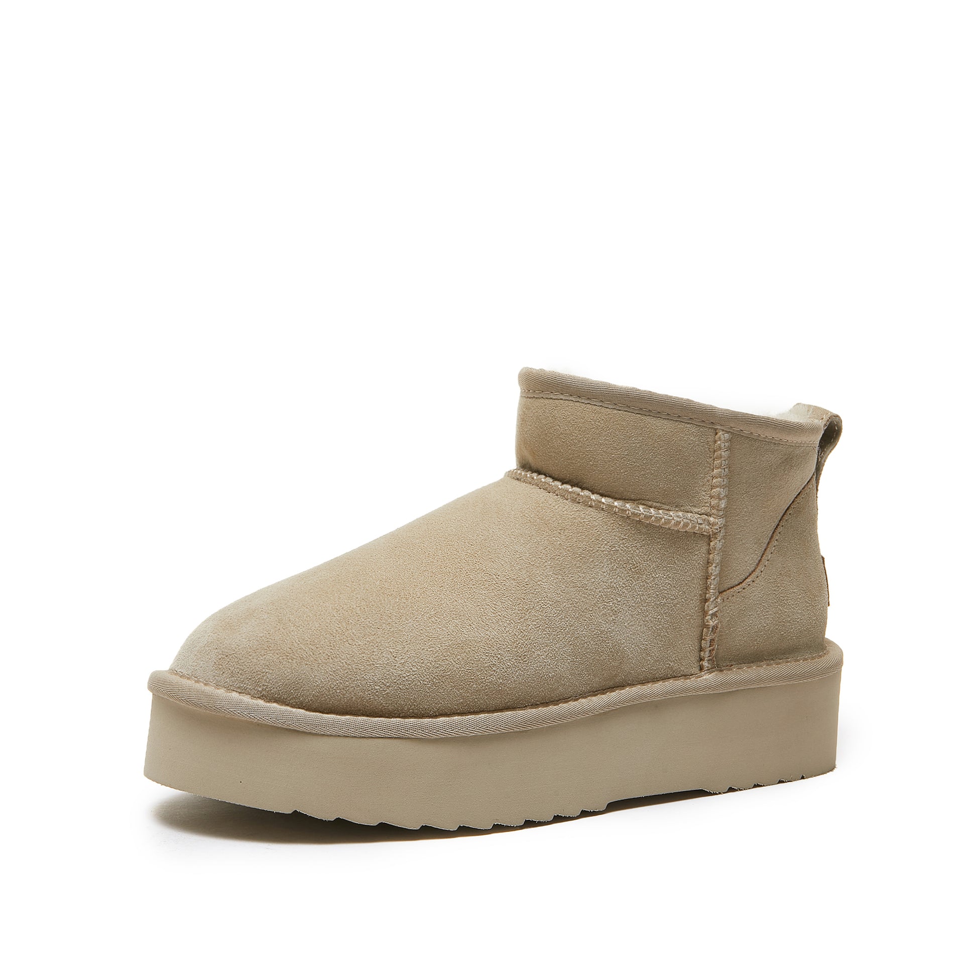 Beige sheepskin ankle boot with flat sole on white background