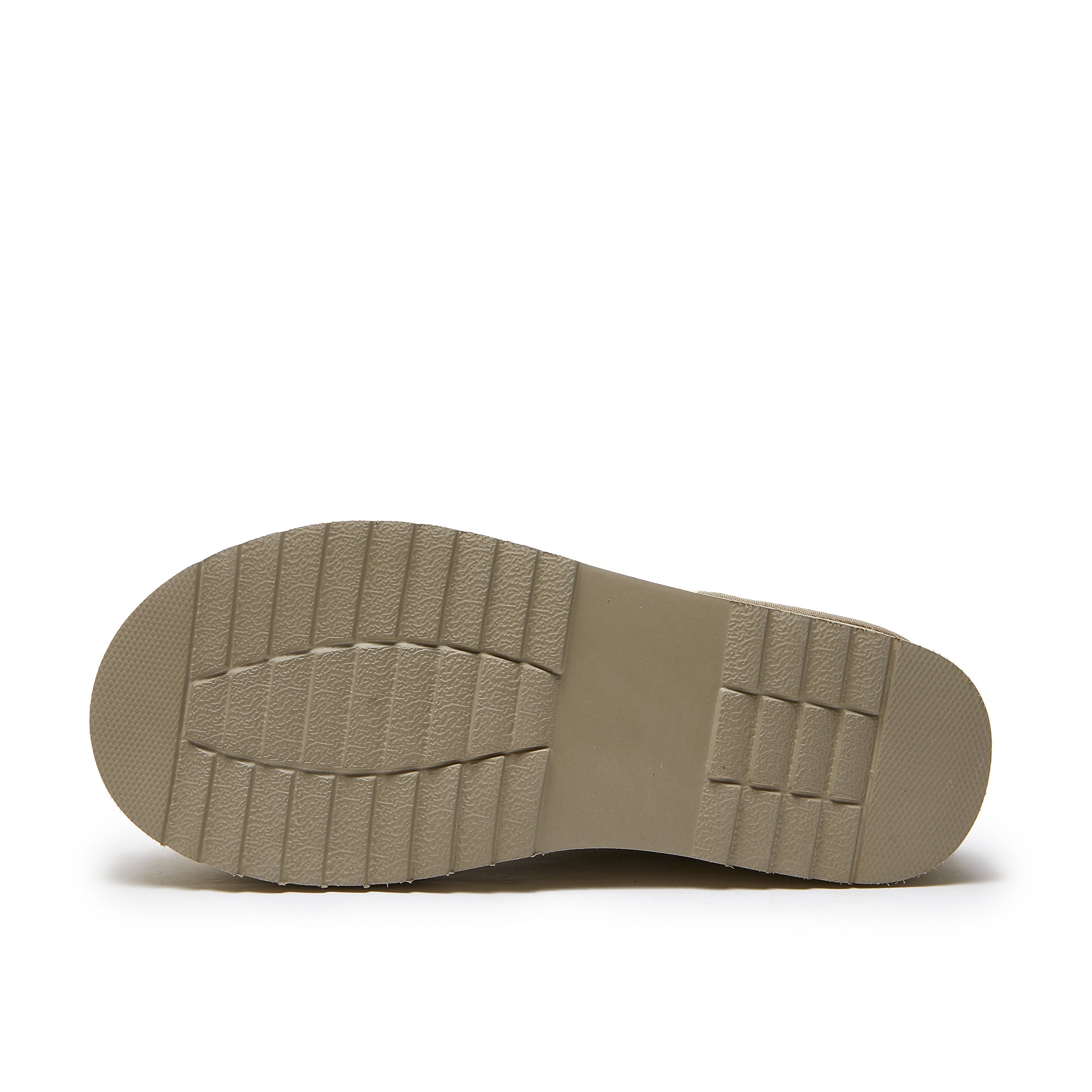 Textured beige rubber sole of a sheepskin boot with tread pattern, isolated on white