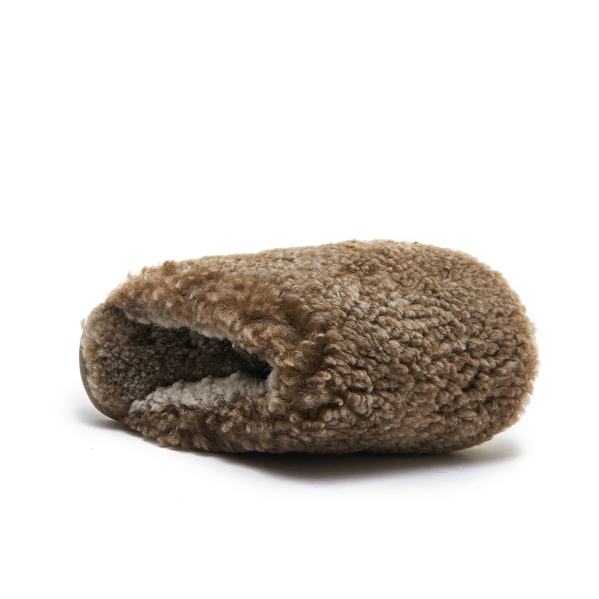 Rolled beige sheepskin blanket with curly wool texture, side view. - Yellow Earth Australia