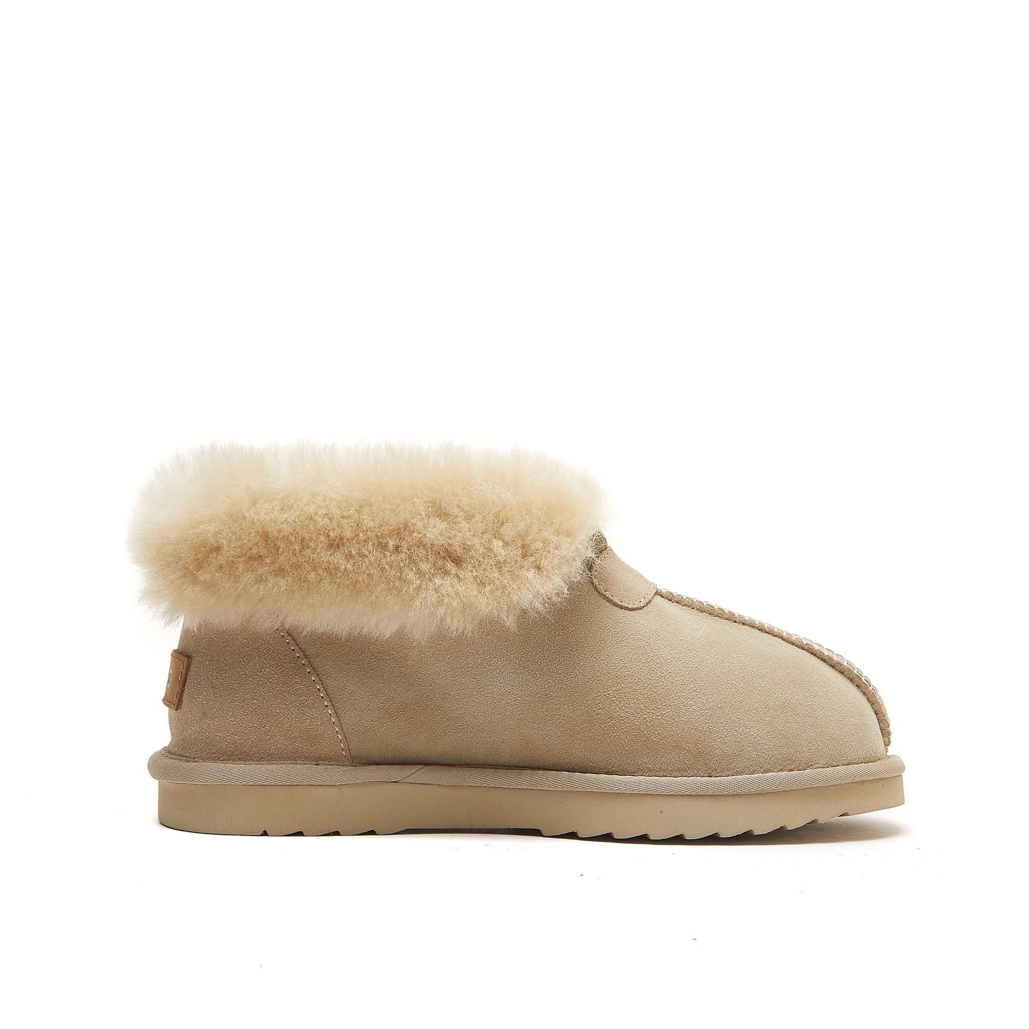 Beige sheepskin ankle boot with fluffy wool collar, soft suede upper, and rubber sole on white background