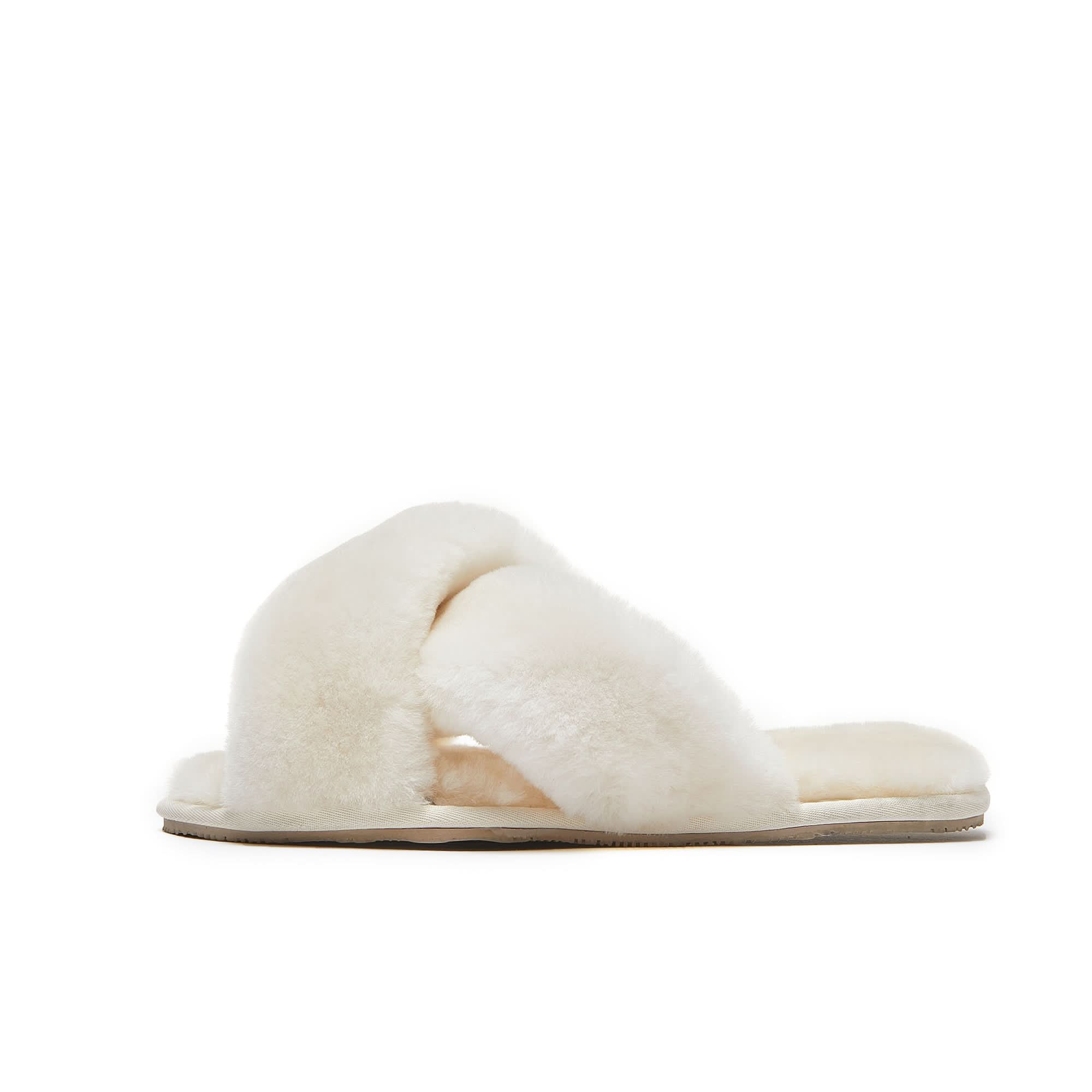 Cream sheepskin cross-strap slipper with fluffy wool lining, side view. - Yellow Earth Australia