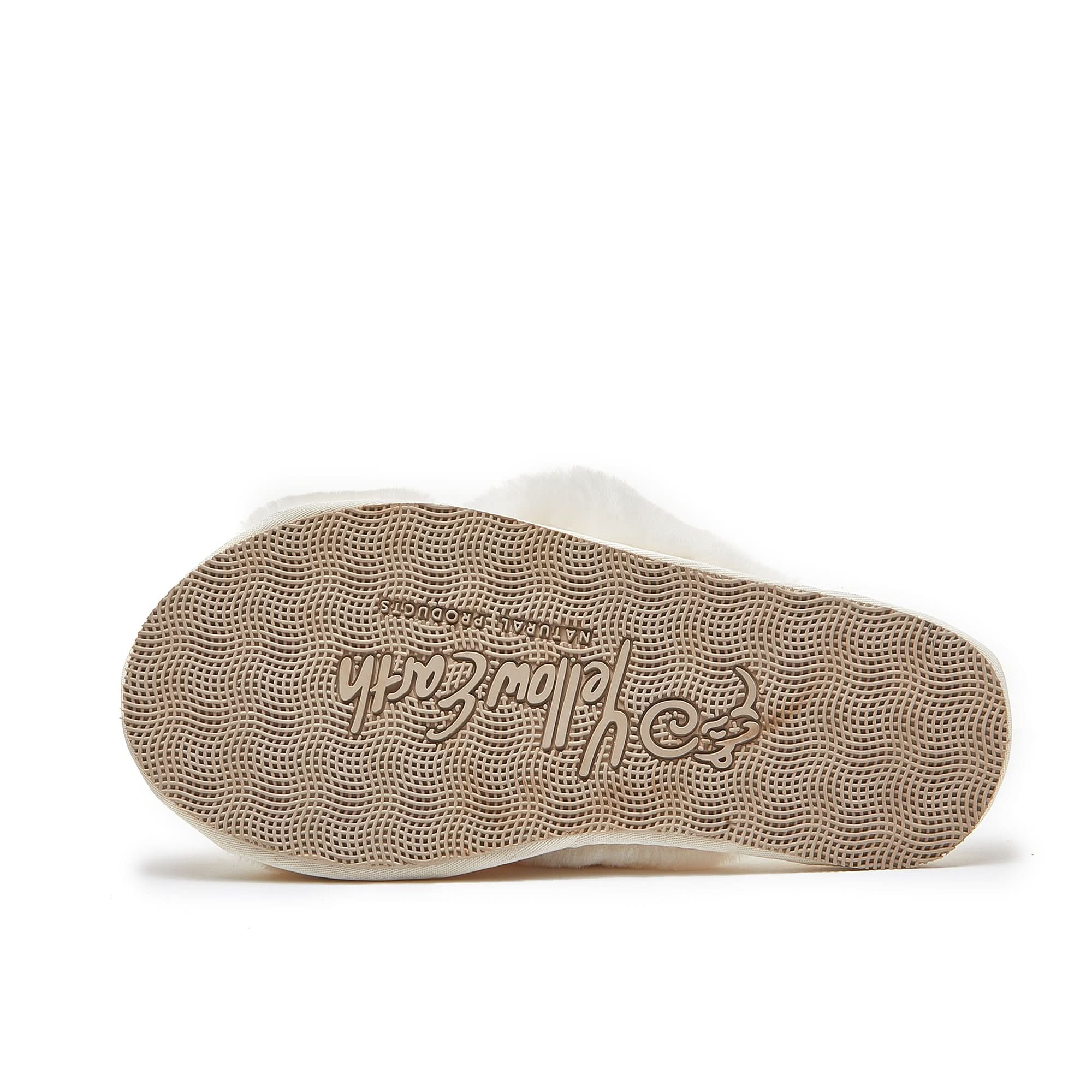 Beige sheepskin slipper sole with textured grip pattern, side view. - Yellow Earth Australia
