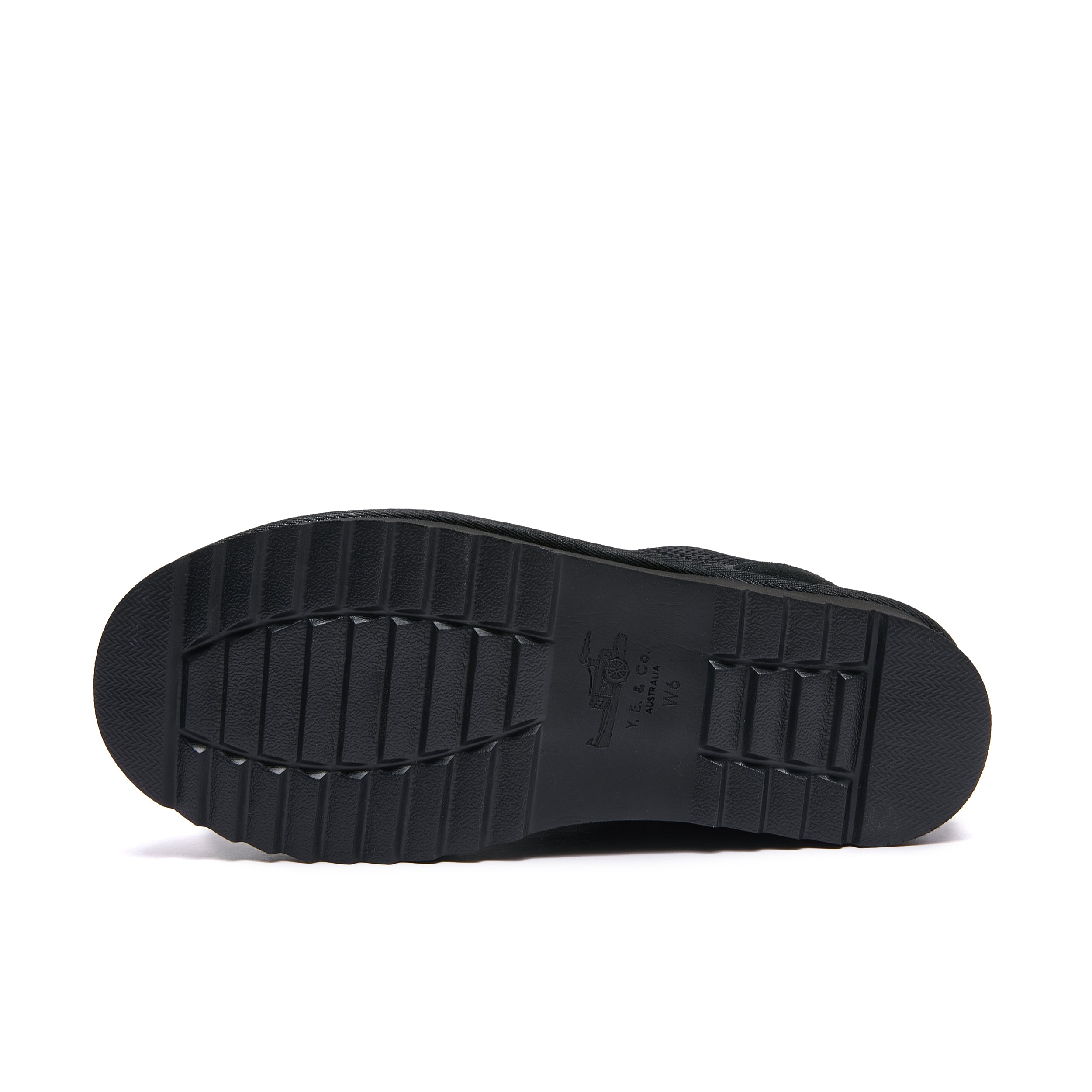 Leslie Chunky Sheepskin-Lined Sneaker in Black - The black rubber outsole of a shoe, shown from a top-down view against a plain white background.