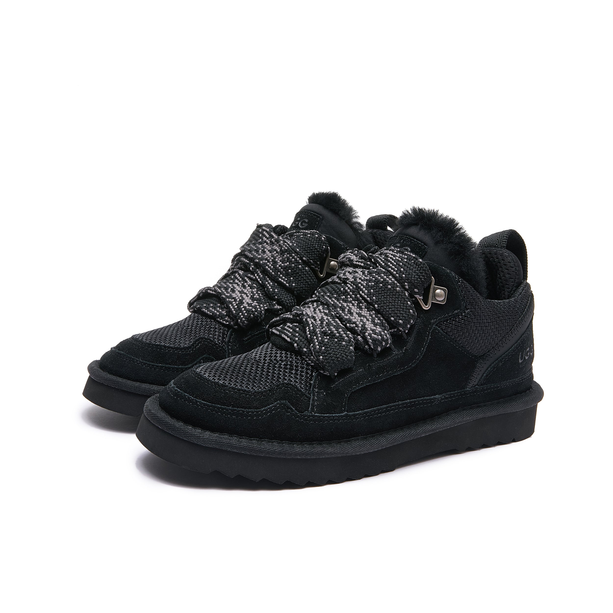 Leslie Chunky Sheepskin-Lined Sneaker in Black - A pair of black mid-top winter sneakers with fuzzy black shearling lining, knit lace details, and thick black soles, shown on a plain white background.