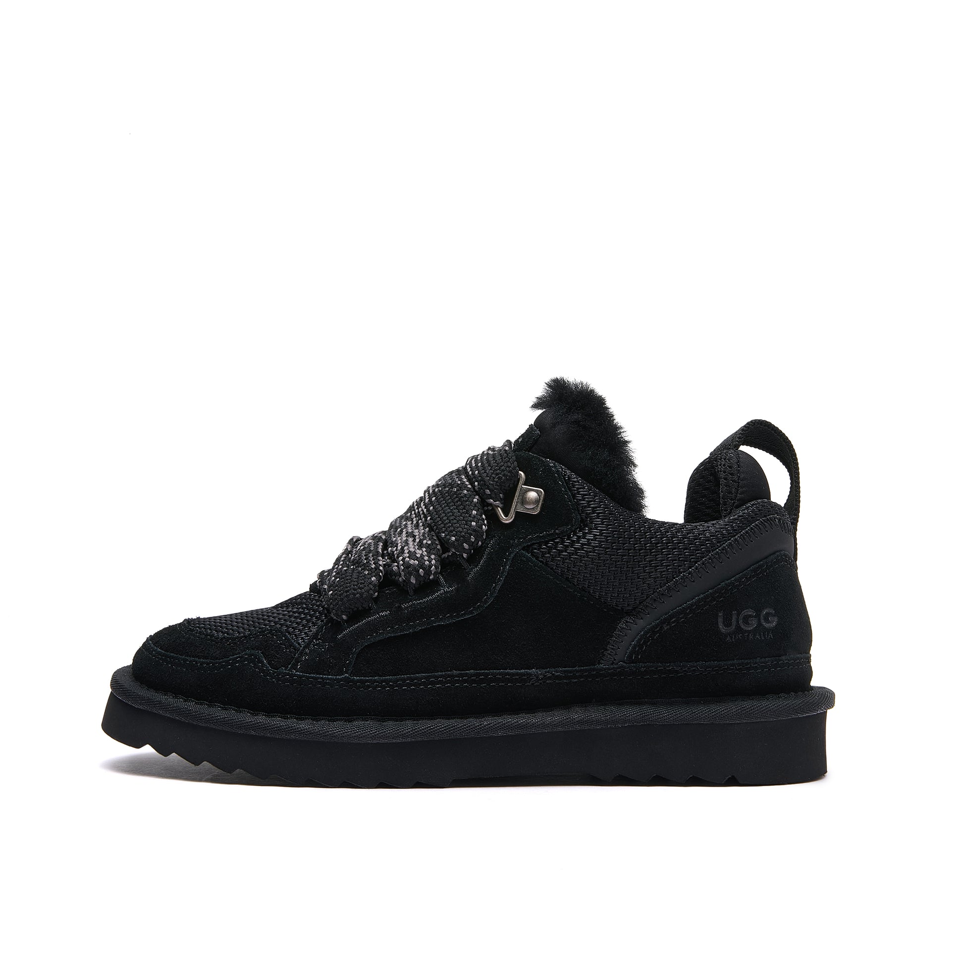 Leslie Chunky Sheepskin-Lined Sneaker in Black - A black Ugg lace-up ankle boot with a fuzzy collar, textured knit upper, and a thick black sole, shown from a side profile on a white background.