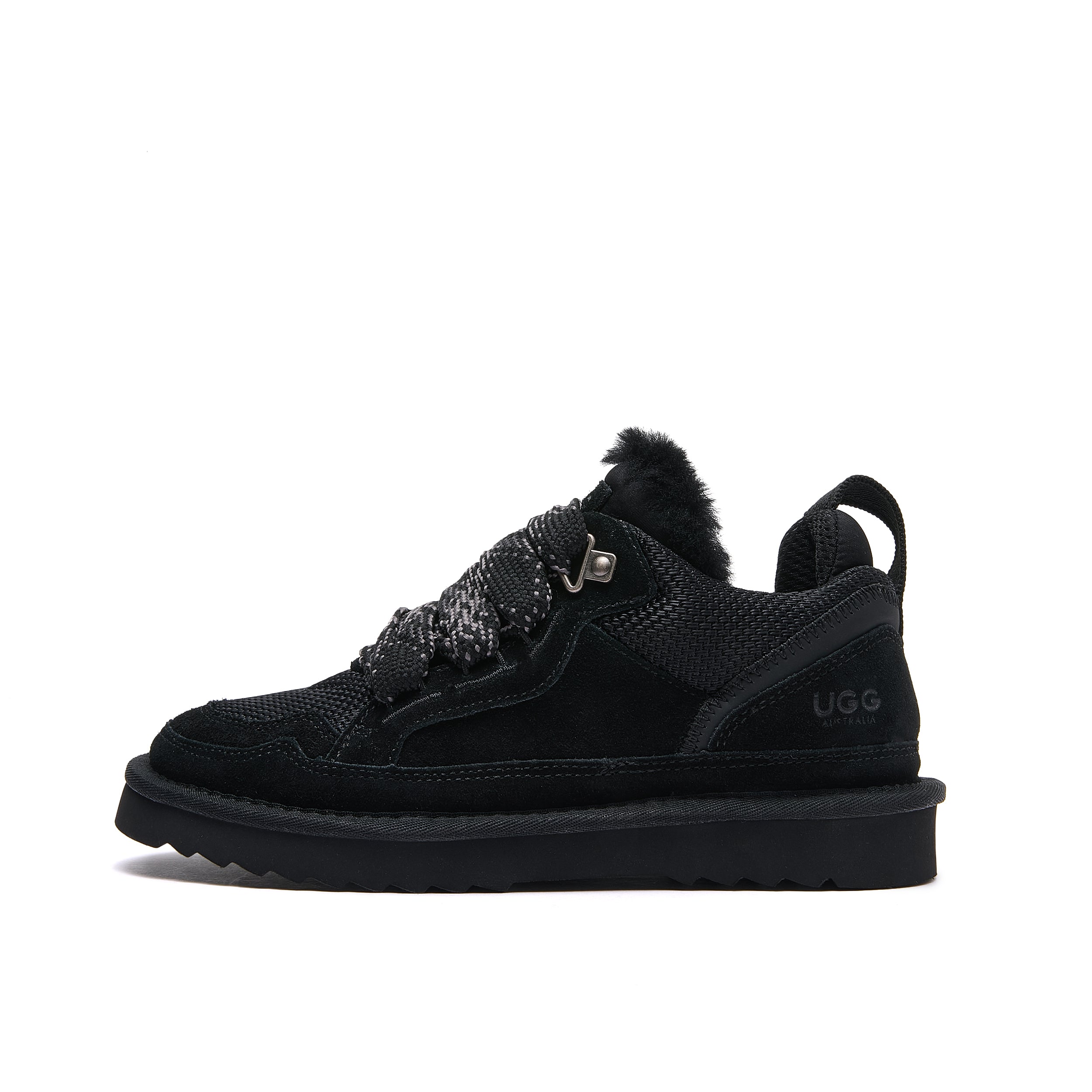 Leslie Chunky Sheepskin-Lined Sneaker in Black - A black Ugg lace-up ankle boot with a fuzzy collar, textured knit upper, and a thick black sole, shown from a side profile on a white background.