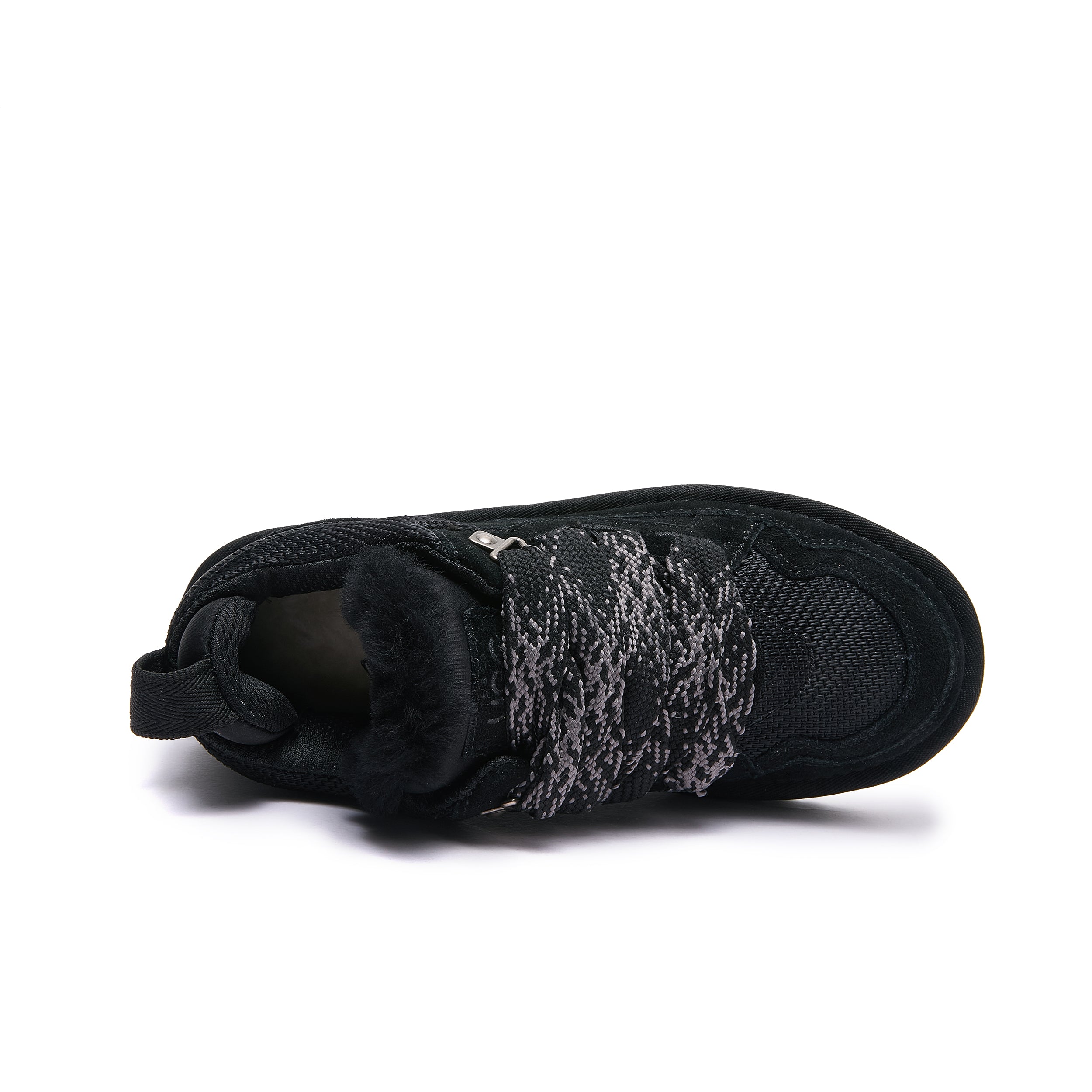 Leslie Chunky Sheepskin-Lined Sneaker in Black - A black sneaker with a fuzzy black wool collar and a gray and black knit strap across the upper, shown from a side profile on a white background.