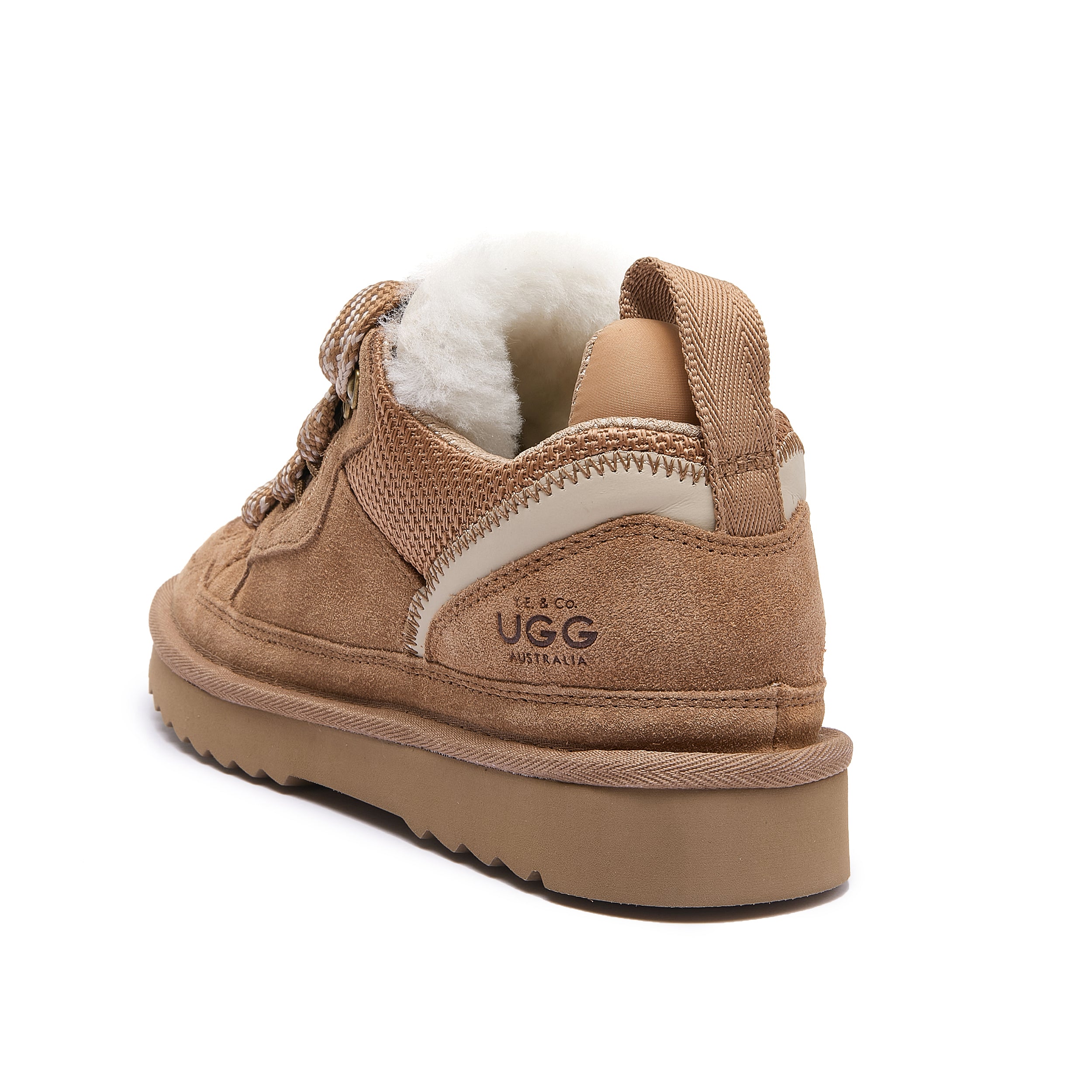 Leslie Chunky Sheepskin-Lined Sneaker in Chestnut - A tan suede Ugg sneaker boot with a white shearling lining, shown from a rear three-quarter angle on a white background.