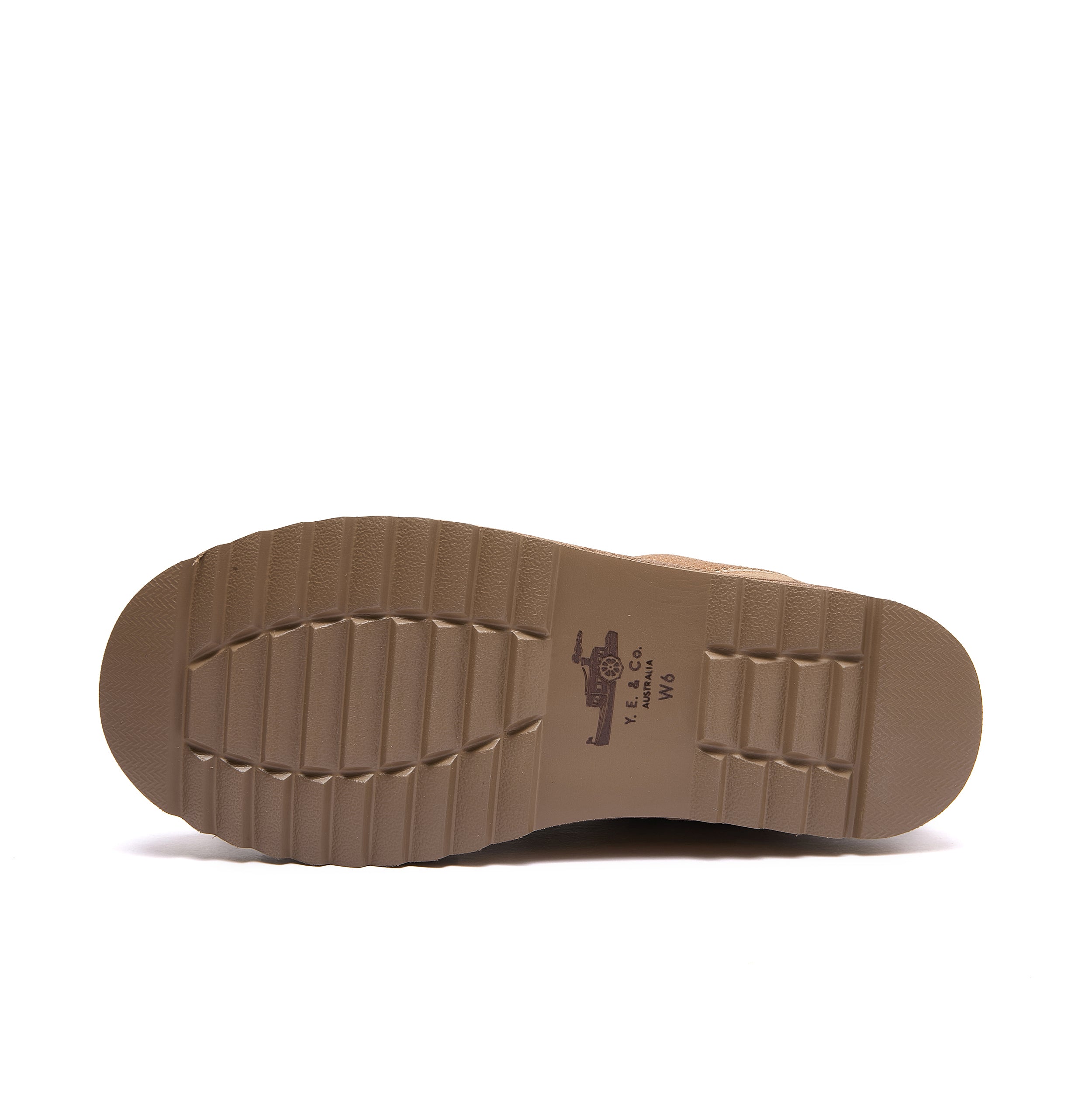 Leslie Chunky Sheepskin-Lined Sneaker in Chestnut - The outsole of a brown boot or shoe, showing a textured tread pattern and a small printed logo in the center, photographed against a solid white background.