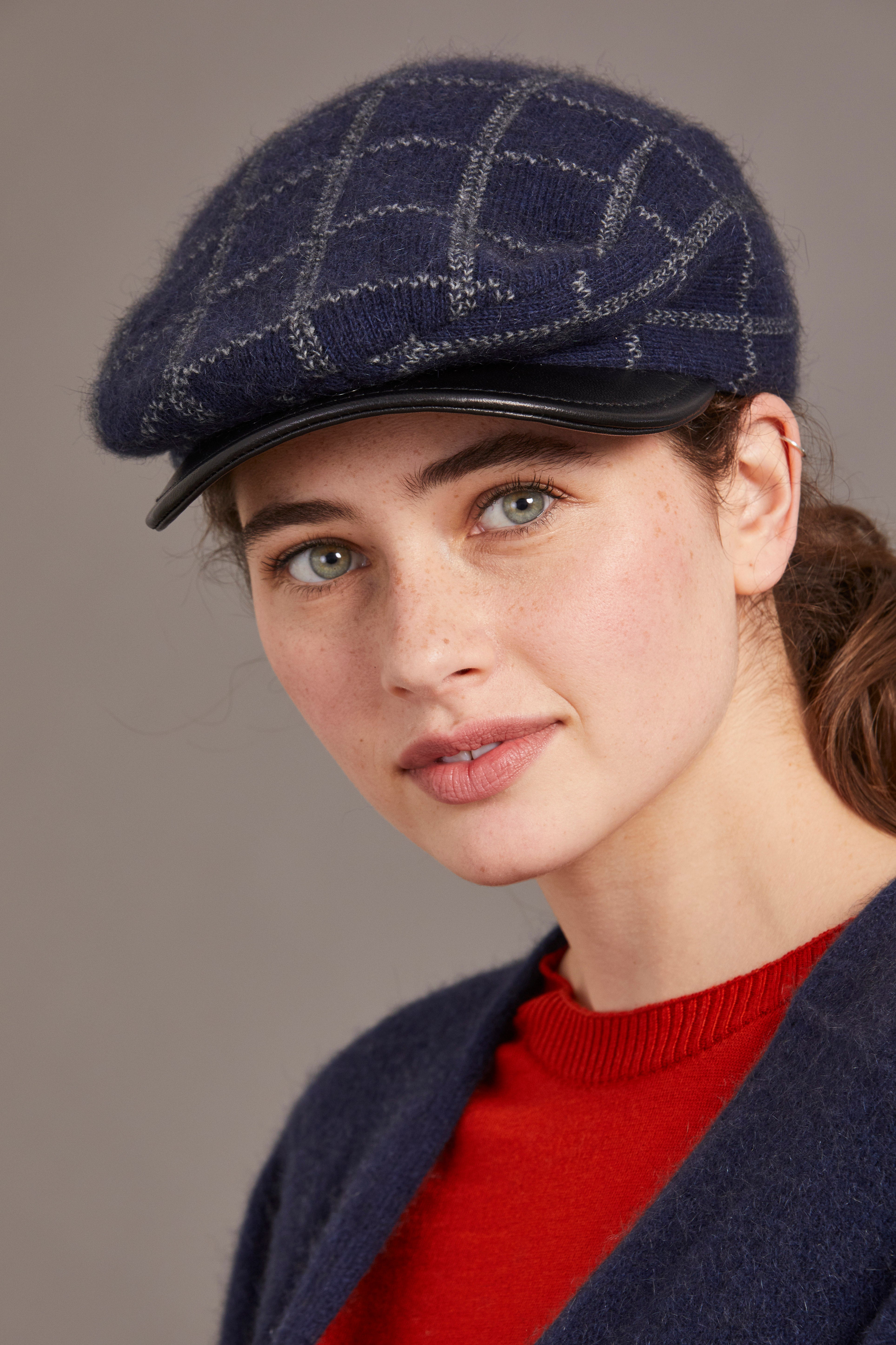 Navy wool flat cap with quilted pattern and leather brim, worn on model, angled side view. - Yellow Earth Australia