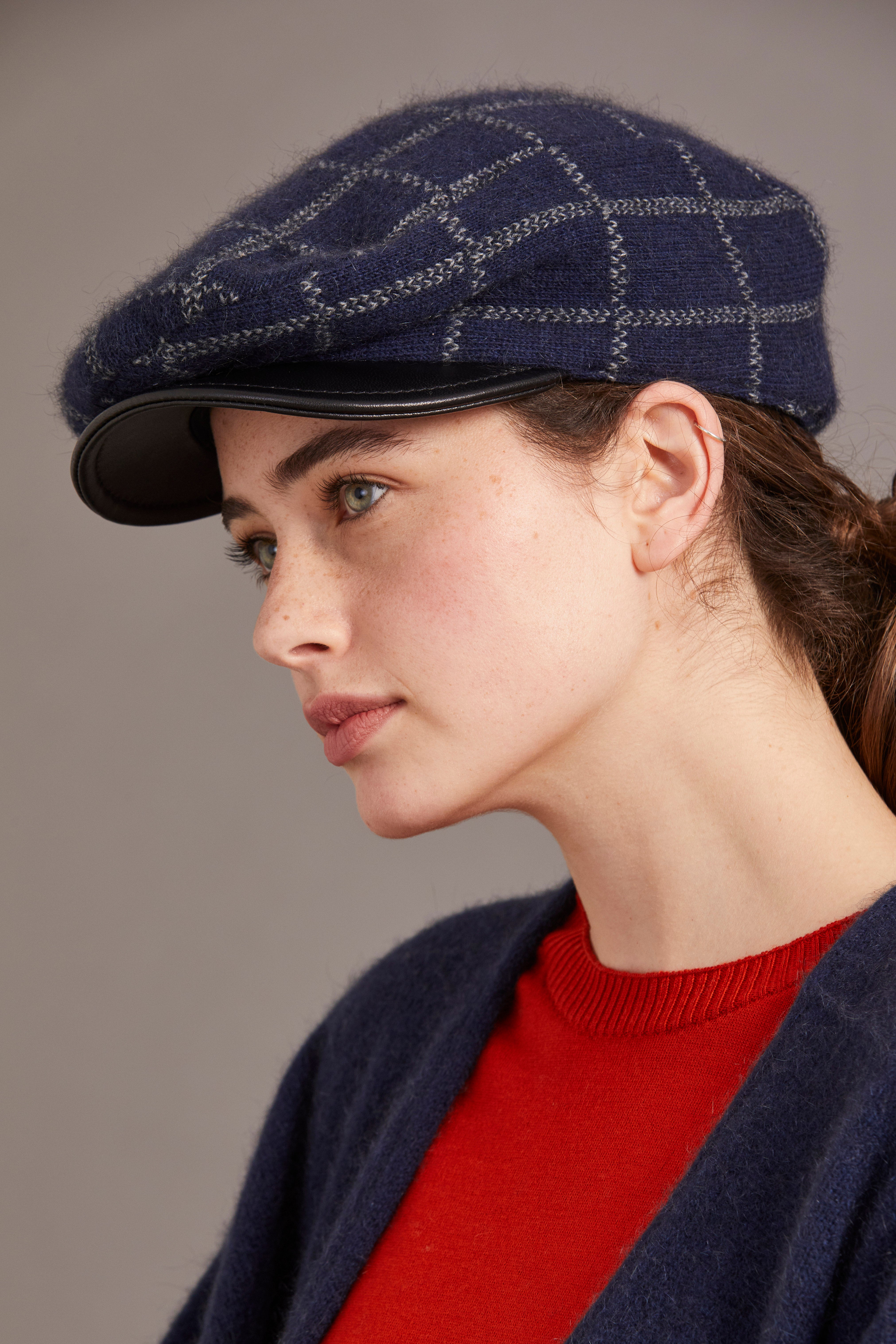 Navy wool newsboy cap with quilted pattern and black leather visor, side profile view. - Yellow Earth Australia