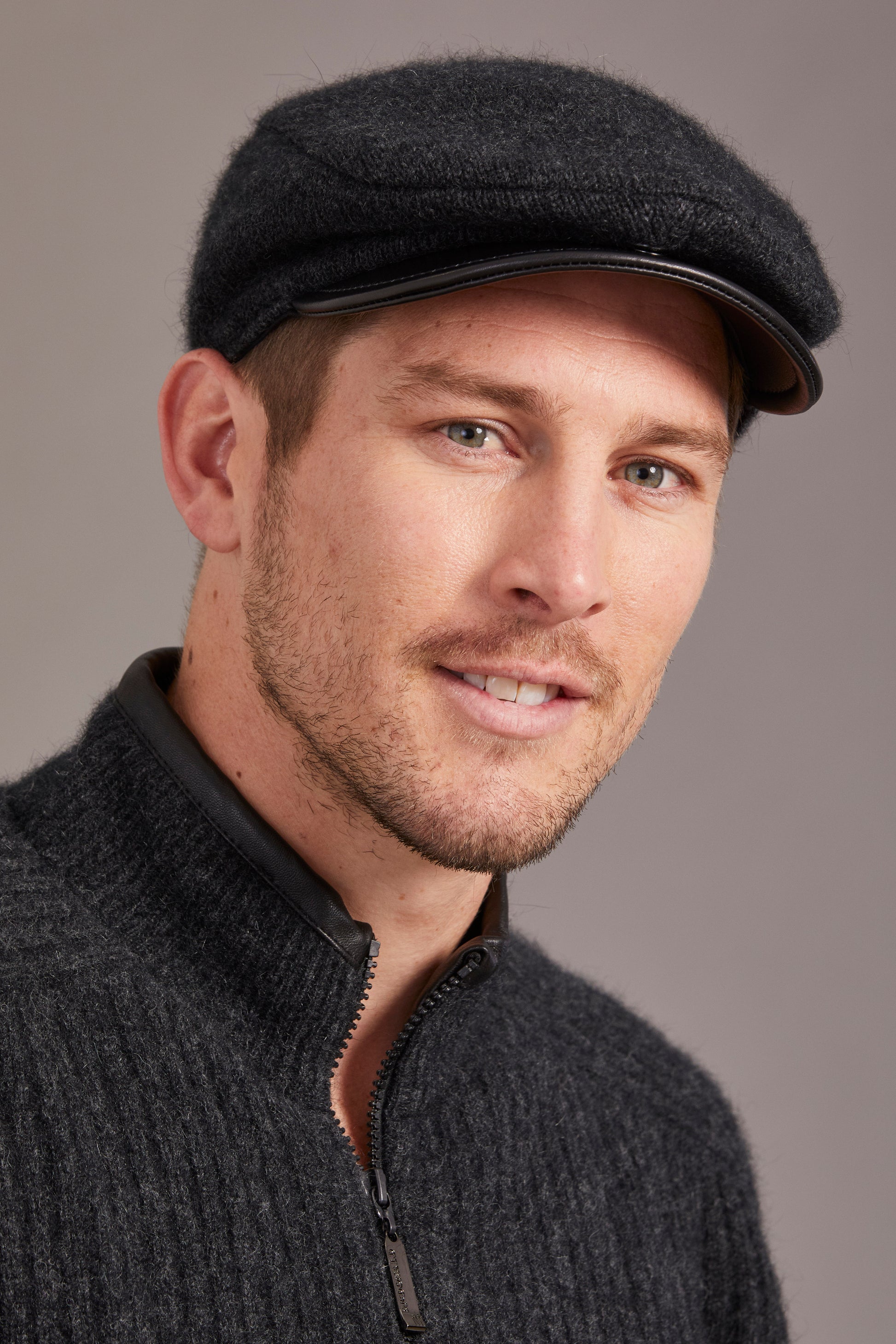 Charcoal wool flat cap with leather trim, front three-quarter view. - Yellow Earth Australia