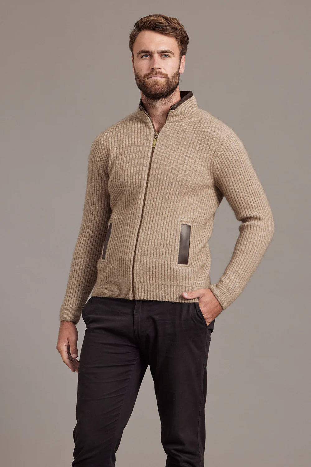 Beige ribbed wool zip-up cardigan with charcoal trim, front view on male model. - Yellow Earth Australia