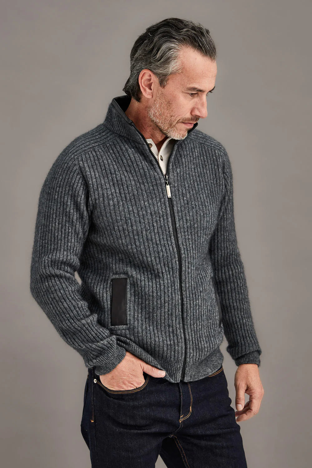 Charcoal ribbed wool zip jacket with hand pockets, side view on model. - Yellow Earth Australia