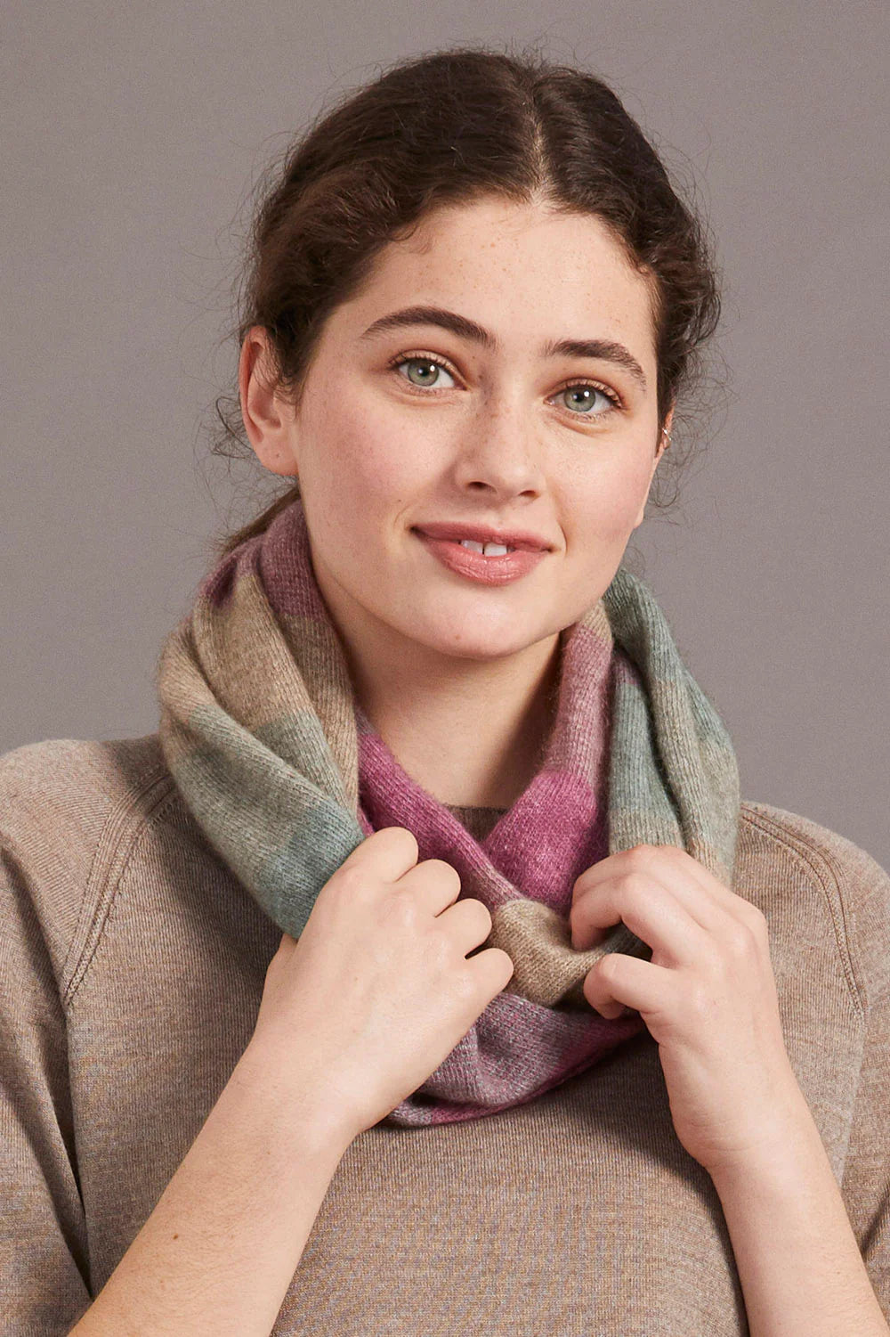 Woman wearing burgundy wool cowl neck sweater in neutral studio setting. - Yellow Earth Australia
