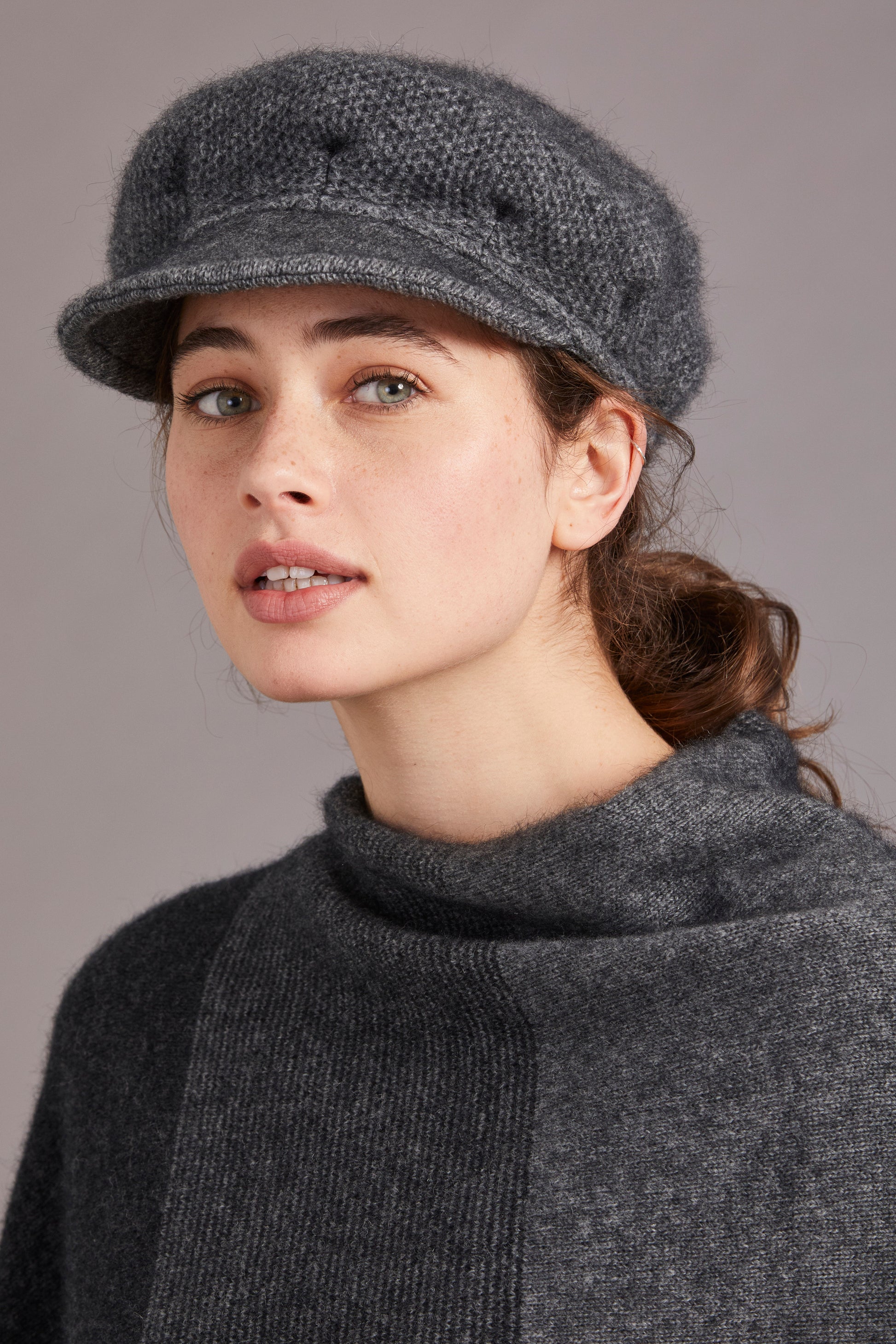 Gray wool newsboy cap worn by woman, displayed side view. - Yellow Earth Australia